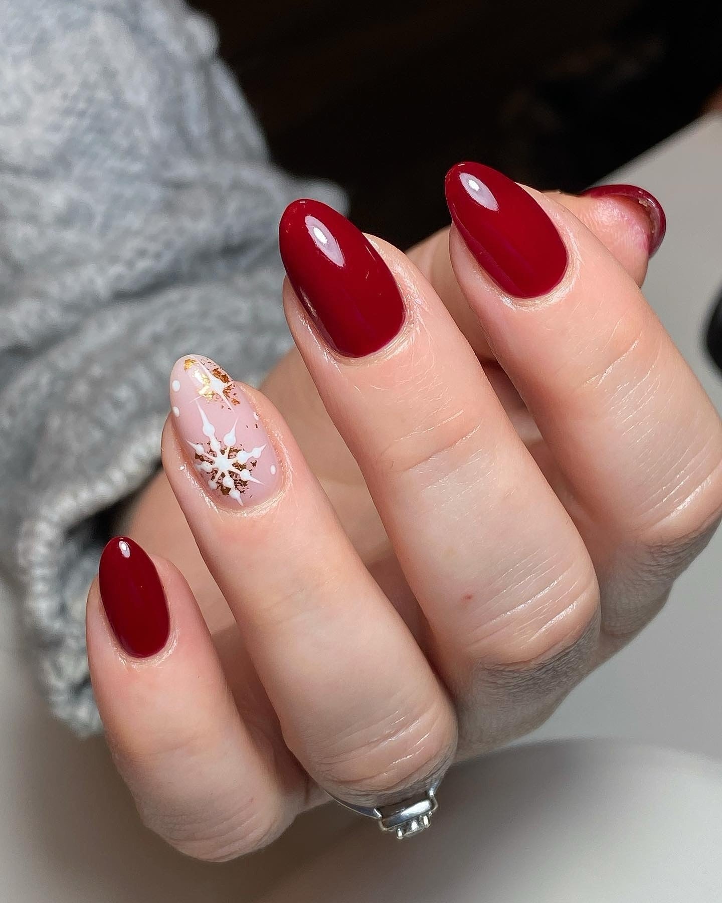 6. Deep Crimson with Rose Gold Snowflakes (Winter Almond Nail Ideas)