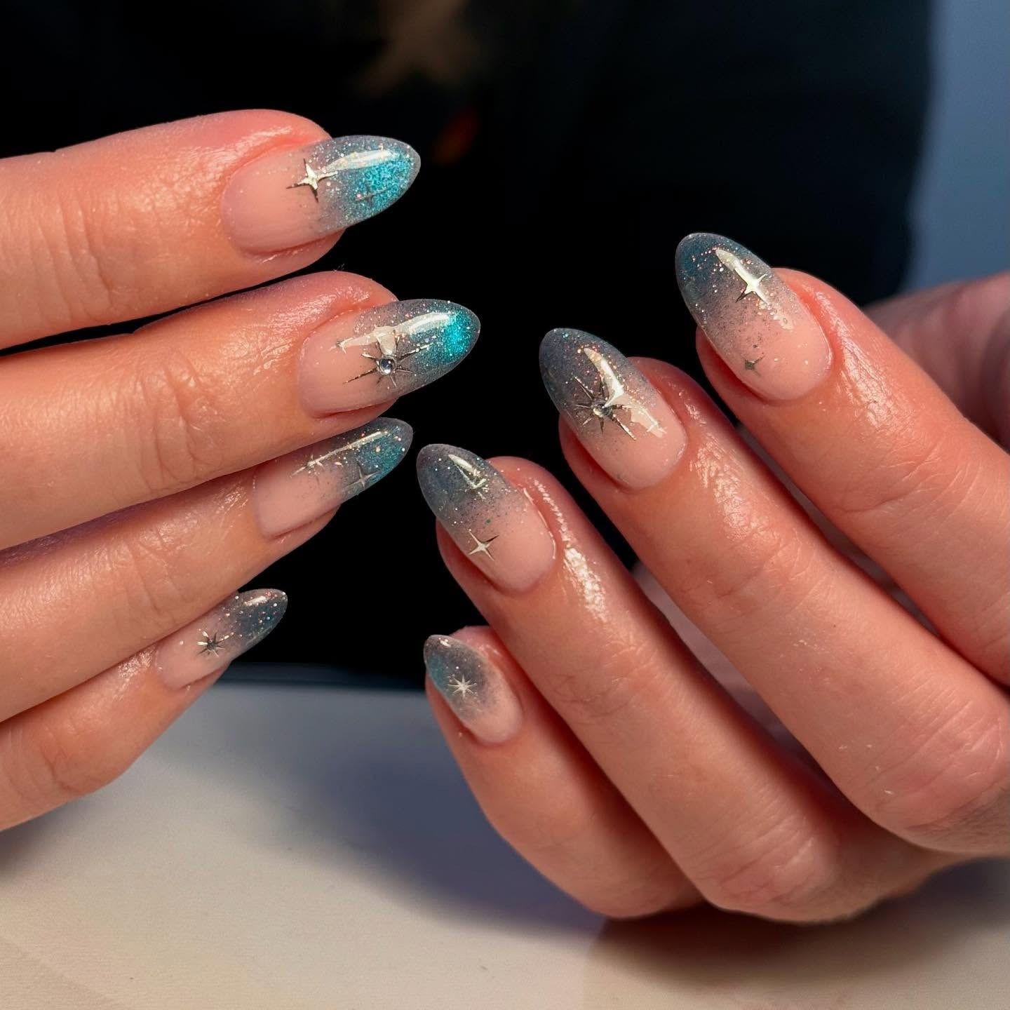 9. Icy Gradient with Silver Starbursts (Winter Almond Nail Ideas)