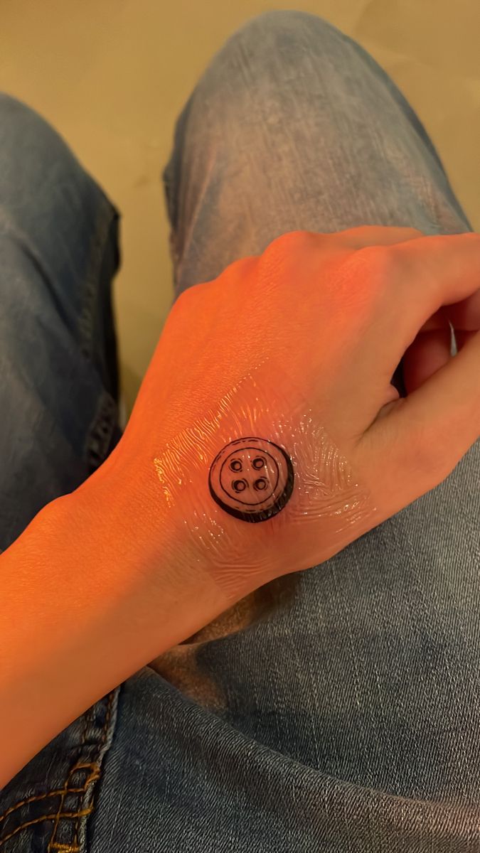 Coraline “buttons for eyes” tattoo