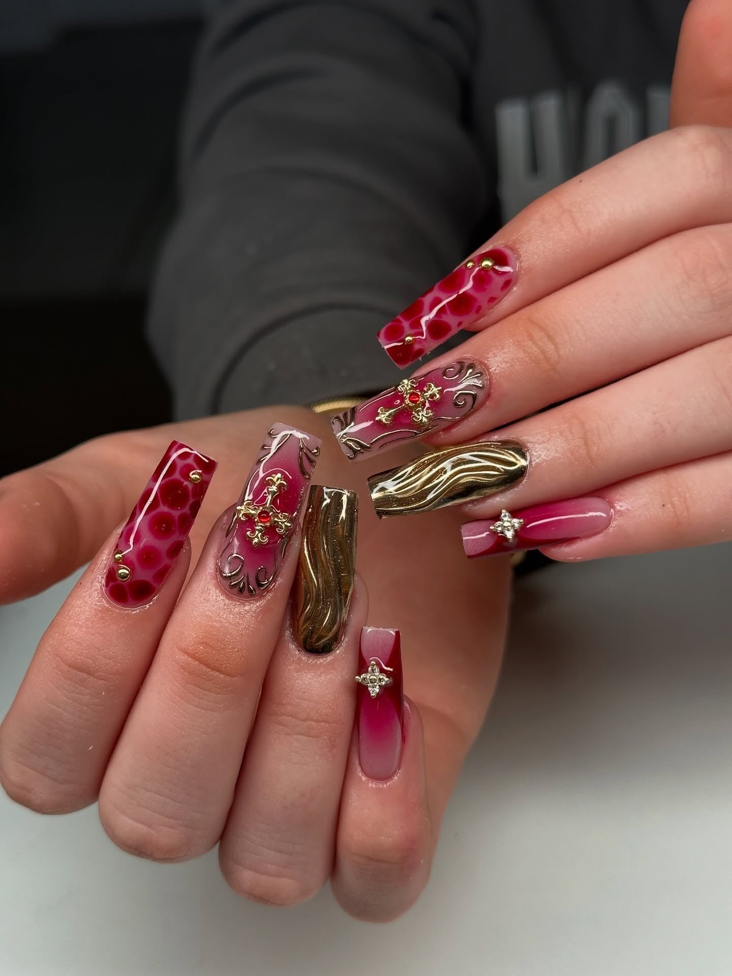 4. Ornate Burgundy and Gold Coffin Nails (Dark Red Coffin Nail Ideas)