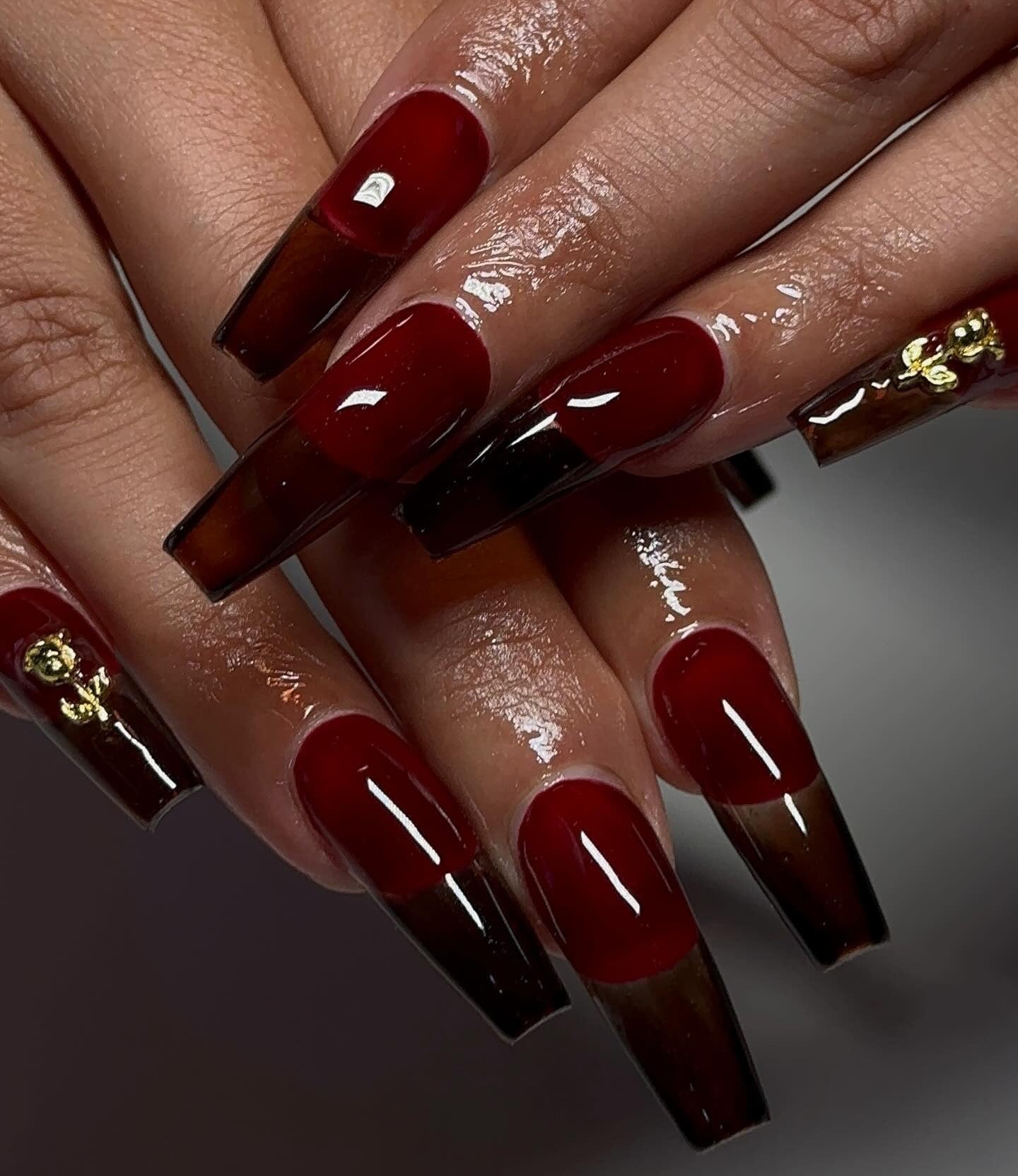 6. Burgundy and Black Ombre Coffin Nails with Gold Accents (Dark Red Coffin Nail Ideas)