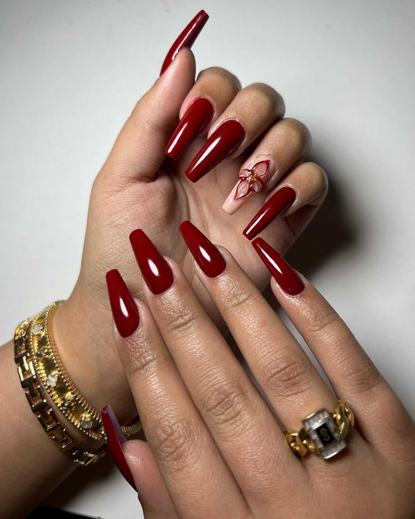 11. Glossy Dark Red Coffin Nails with Orchid Accent (Dark Red Coffin Nail Ideas)