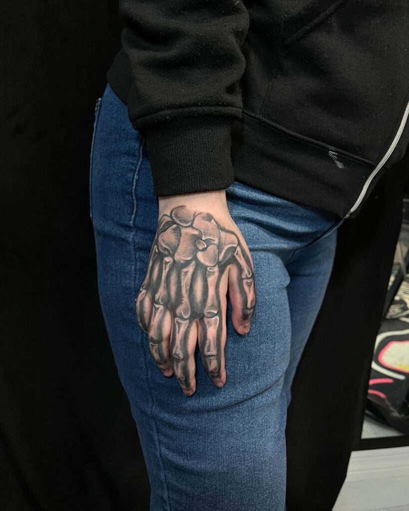 Black And Grey Bone Hand Tattoo