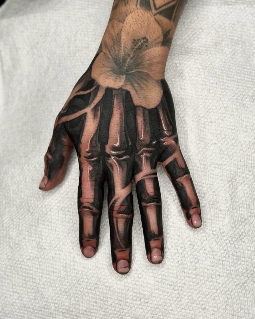Lily And Bone Hand Tattoo