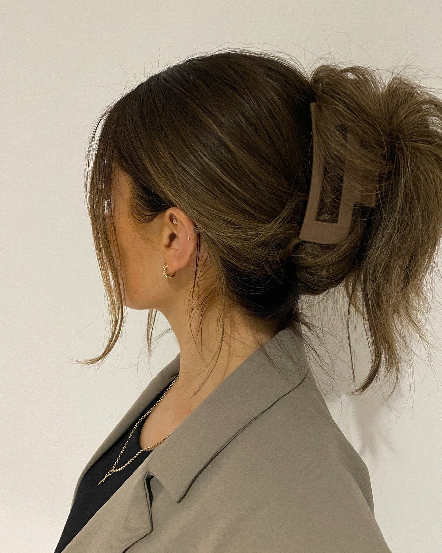7. Messy Textured Updo with Matte Brown Clip (Claw Clip Hairstyles)