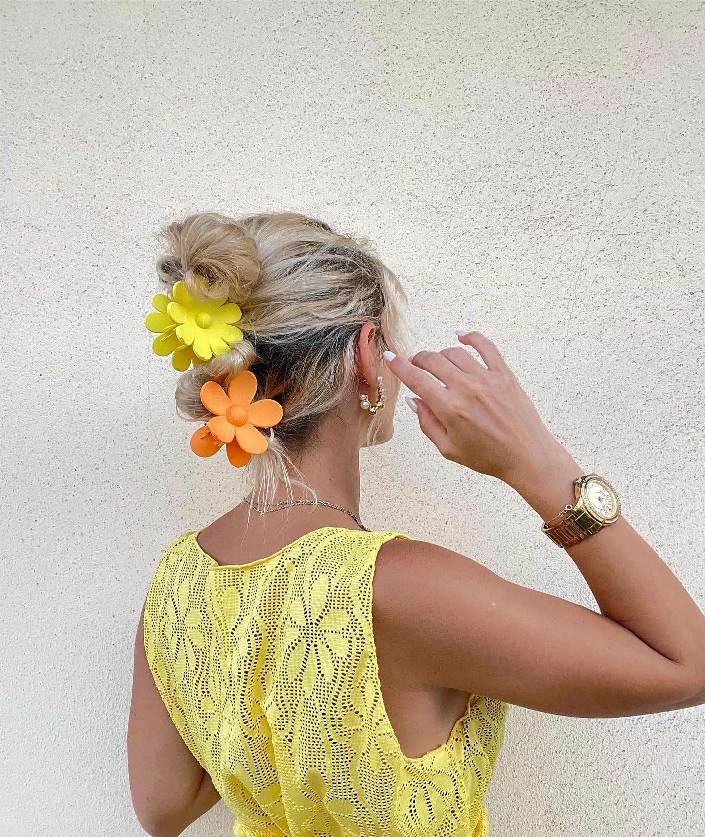 12. Blonde Twisted Bun with Bold Daisy Clips (Claw Clip Hairstyles)