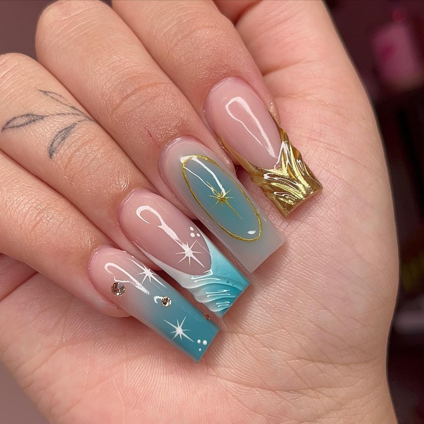 11. Teal Starlight Fade with Golden Crown Detail (Winter Birthday Nail Ideas)