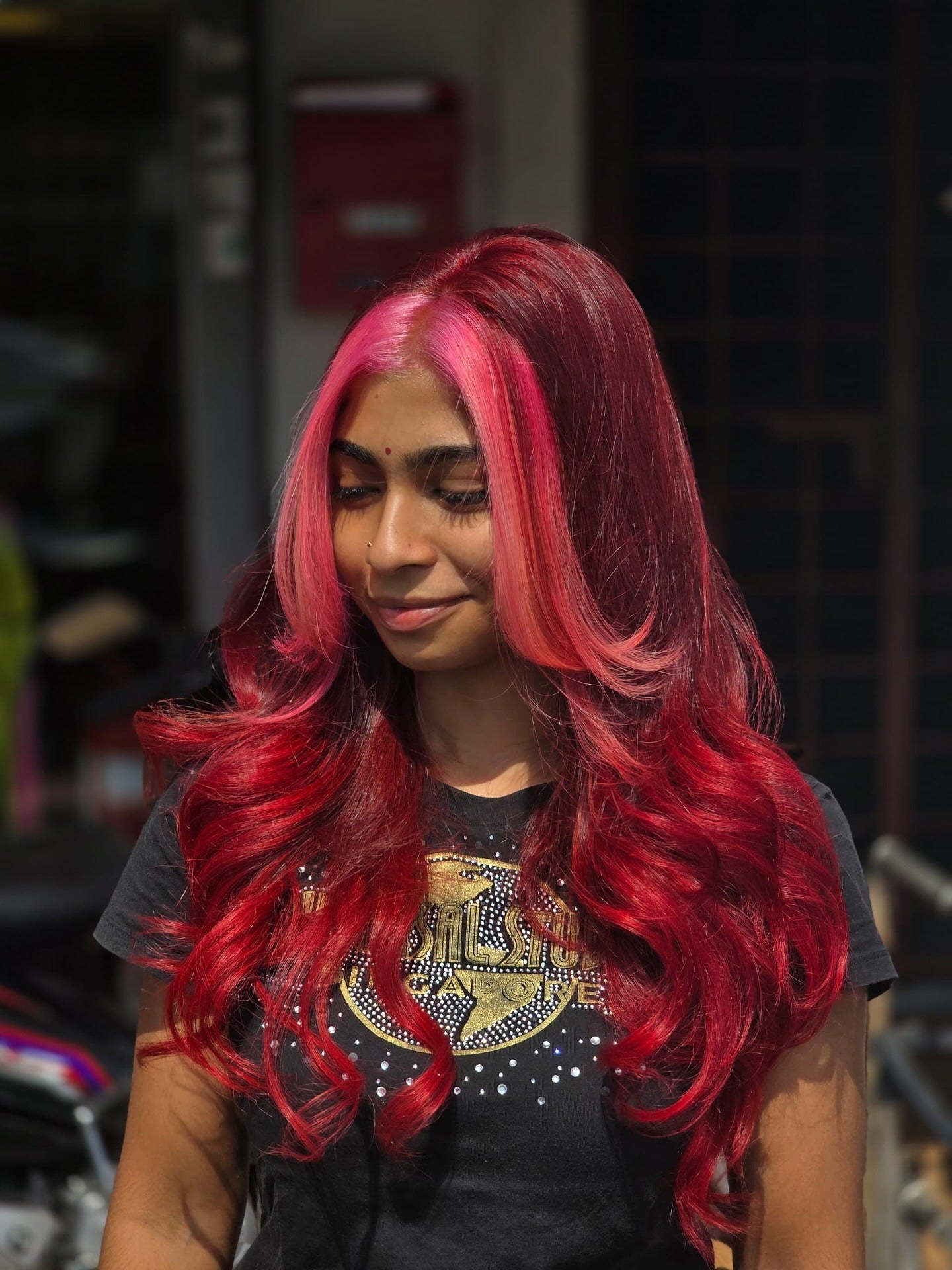 3. Bright Red Curls with Neon Pink Face Frame (Red Hair with Highlights)
