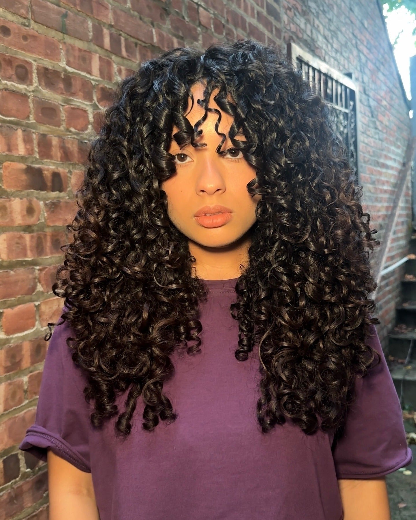 1. Voluminous Black Spiral Perm with Curly Fringe (Perm Hairstyles)