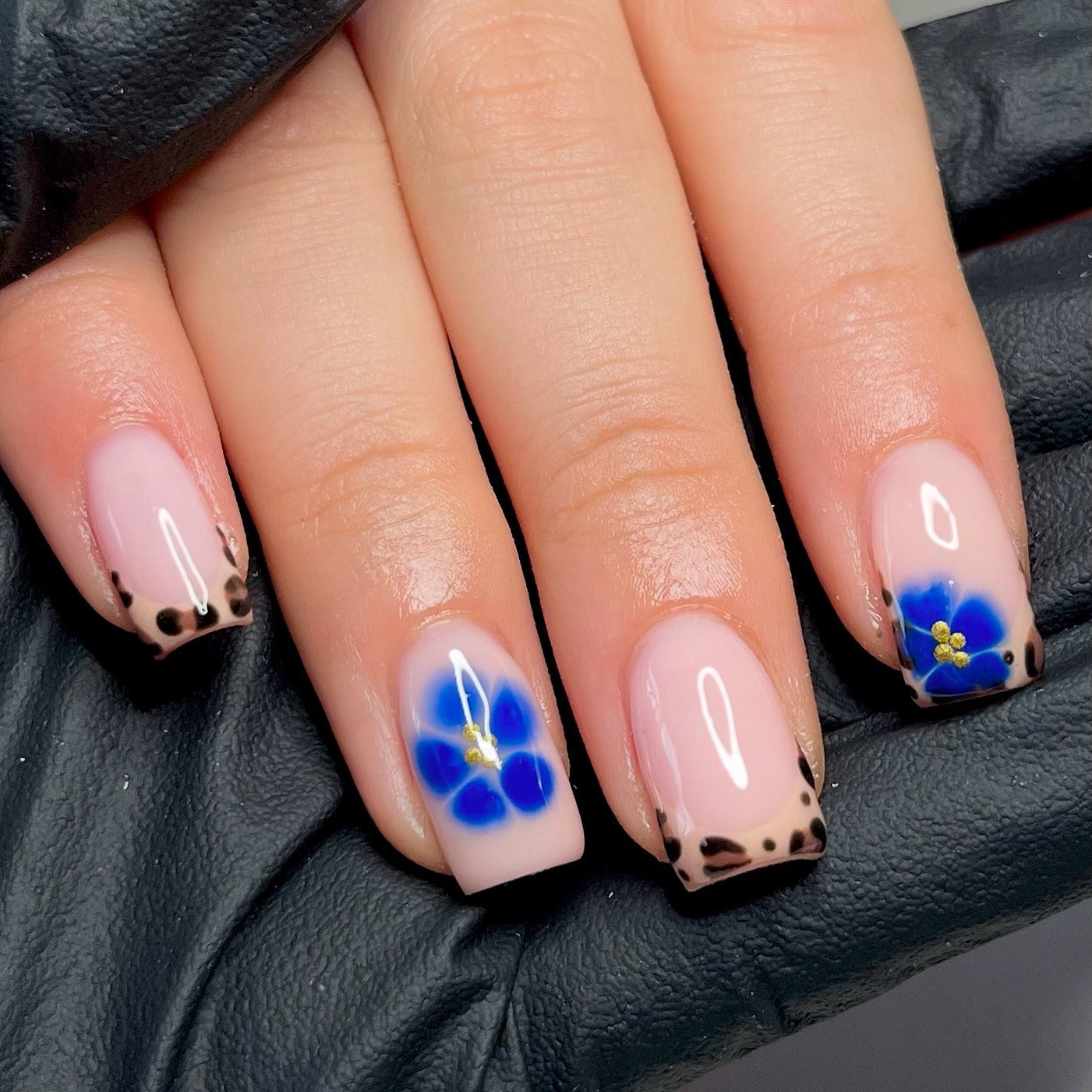 8. Leopard French Tips with Blue Floral Accent (Short Winter Nail Ideas)
