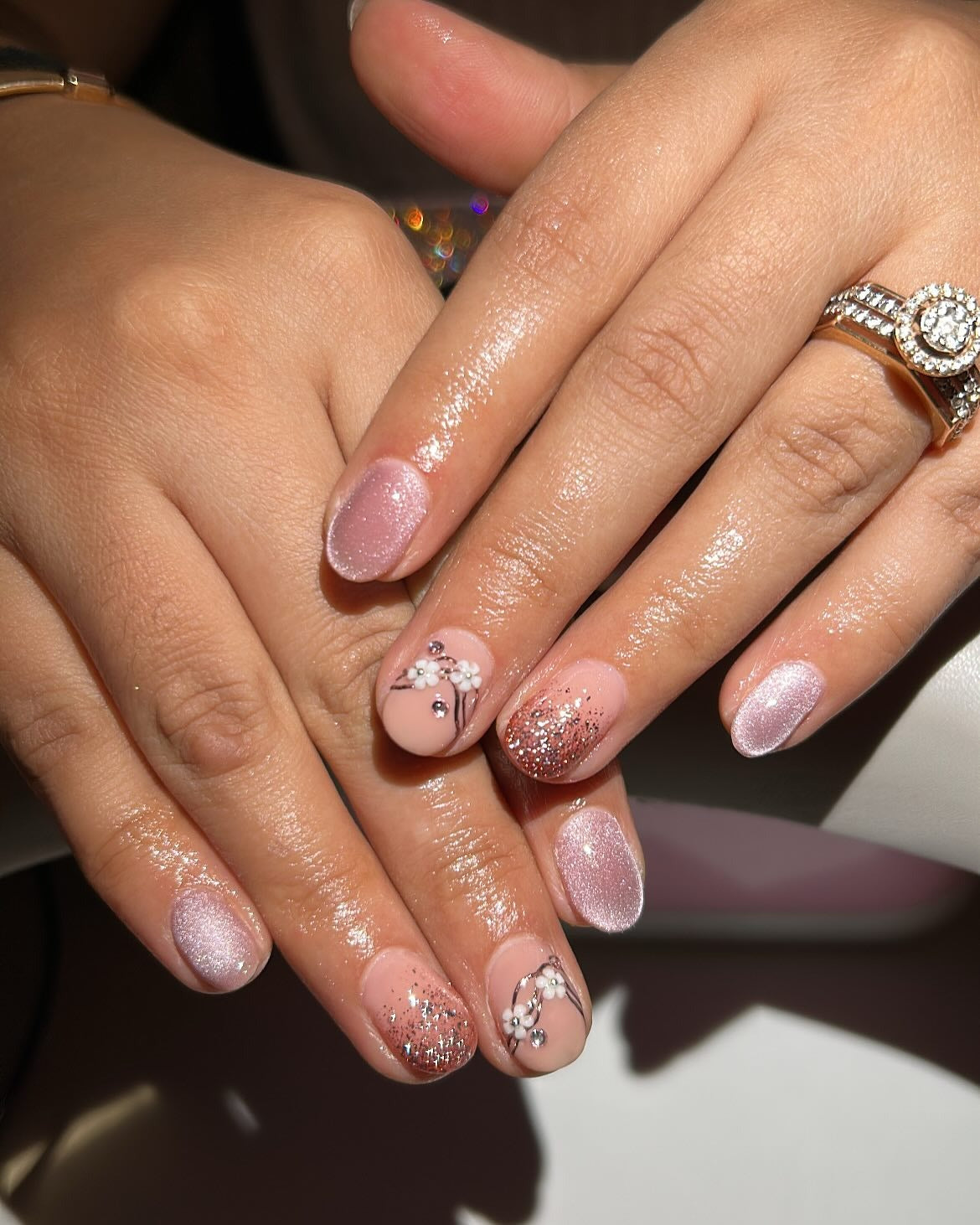 11. Dusty Pink Shimmer with Floral Crystal Accents (Short Winter Nail Ideas)