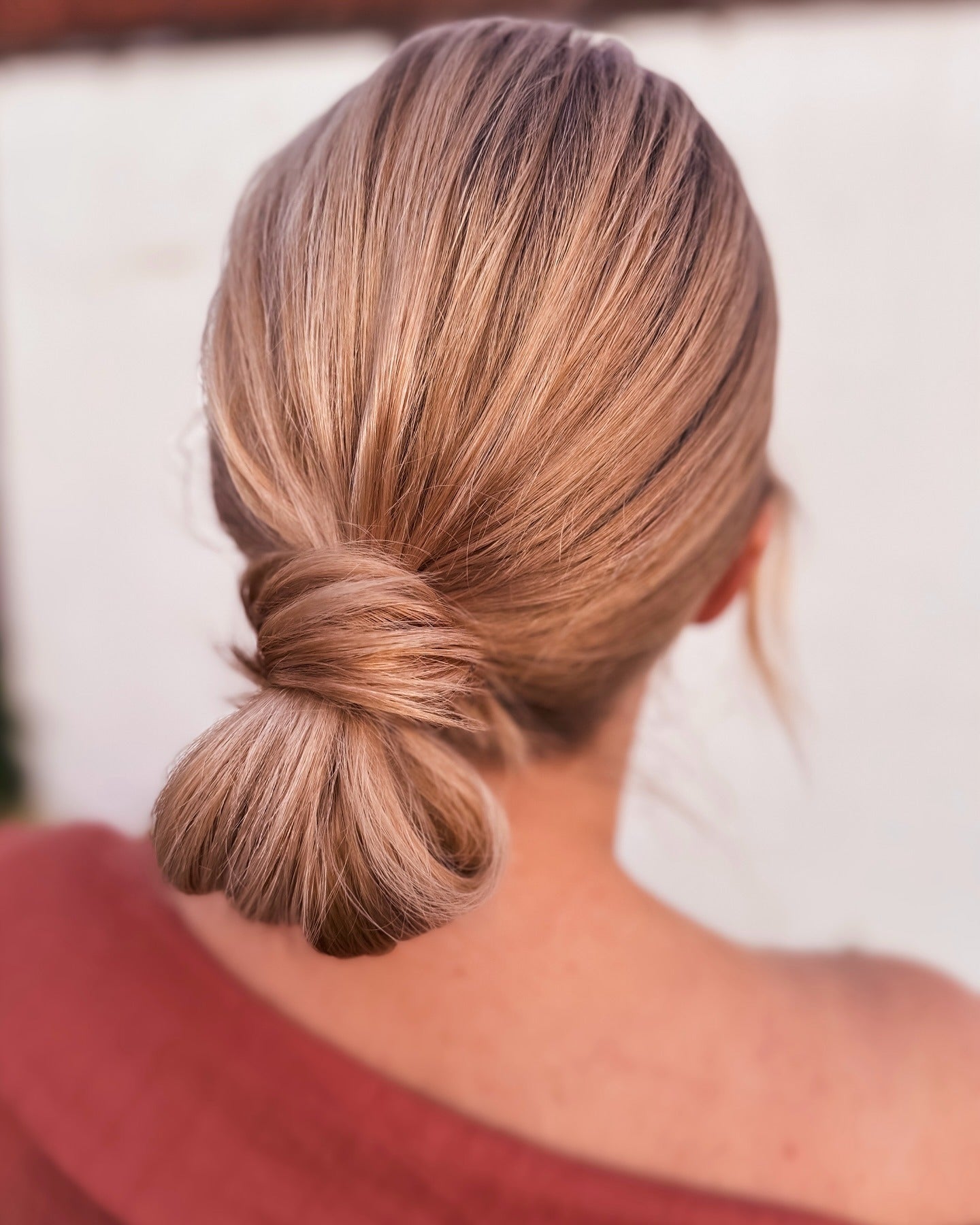 5. Tucked Low Bun in Caramel Ash Blonde (Winter Hairstyles)