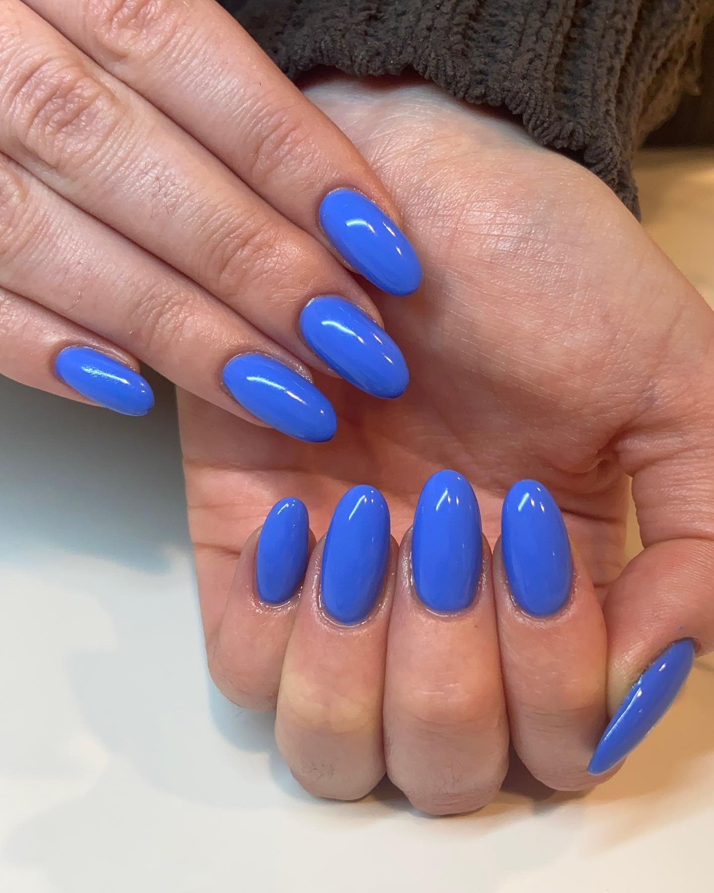 4. Electric Blue Oval Finish (Solid Nail Color Ideas)