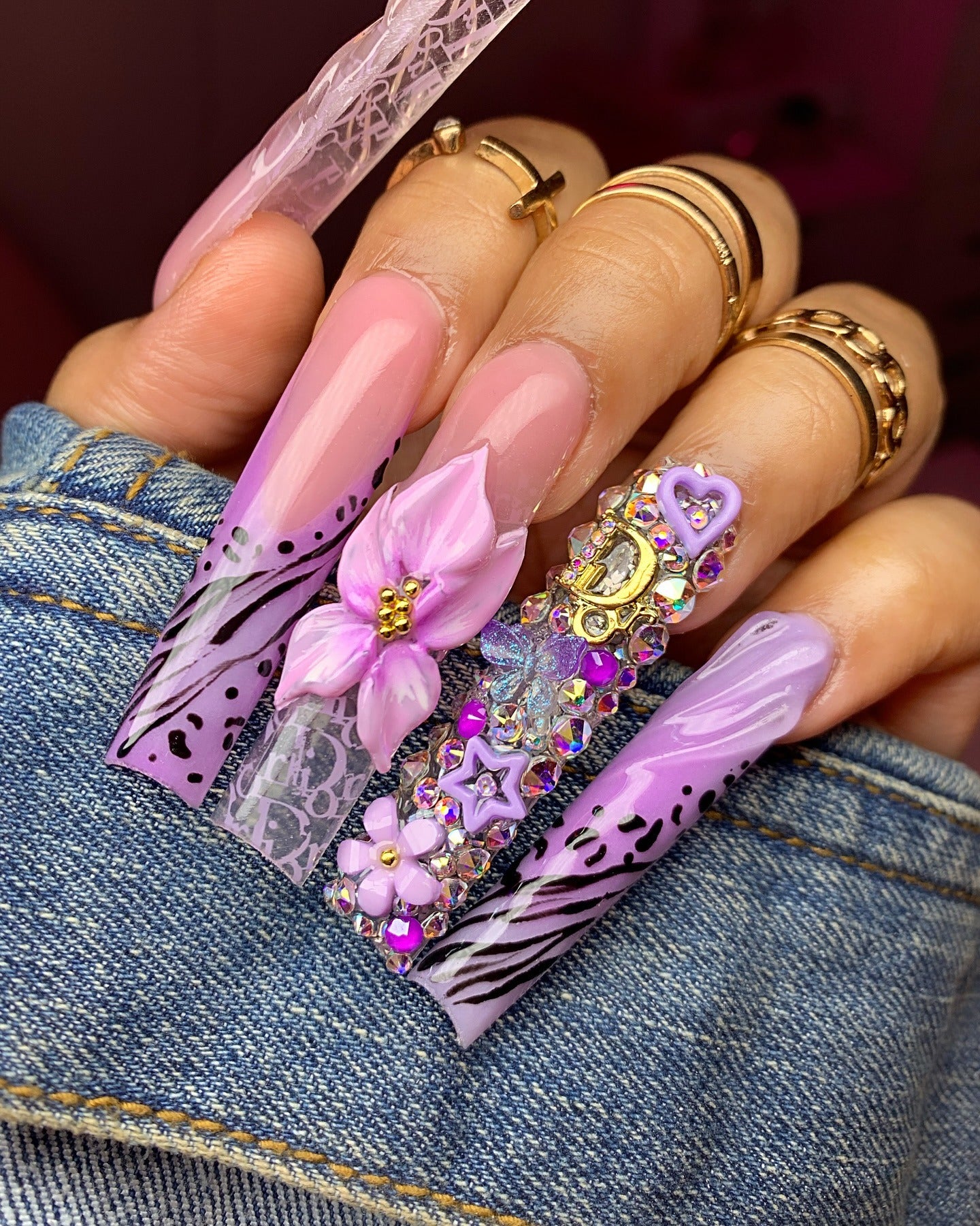 1. Glossy Orchid Glam with 3D Blossoms and Crystals (Purple and Lavender Nail Ideas)