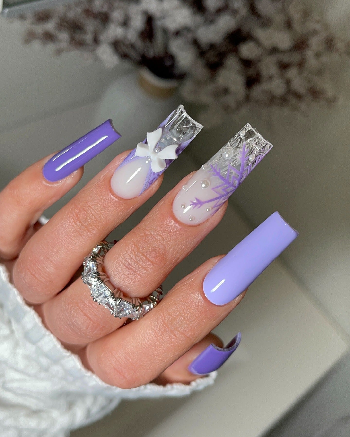 4. Frosted Lilac Glass with Snowflake Art (Purple and Lavender Nail Ideas)