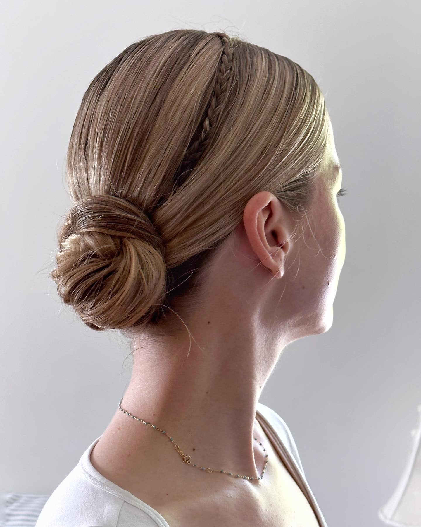 10. Low Wrapped Bun with Side Braid Detail (Simple Hairstyles)