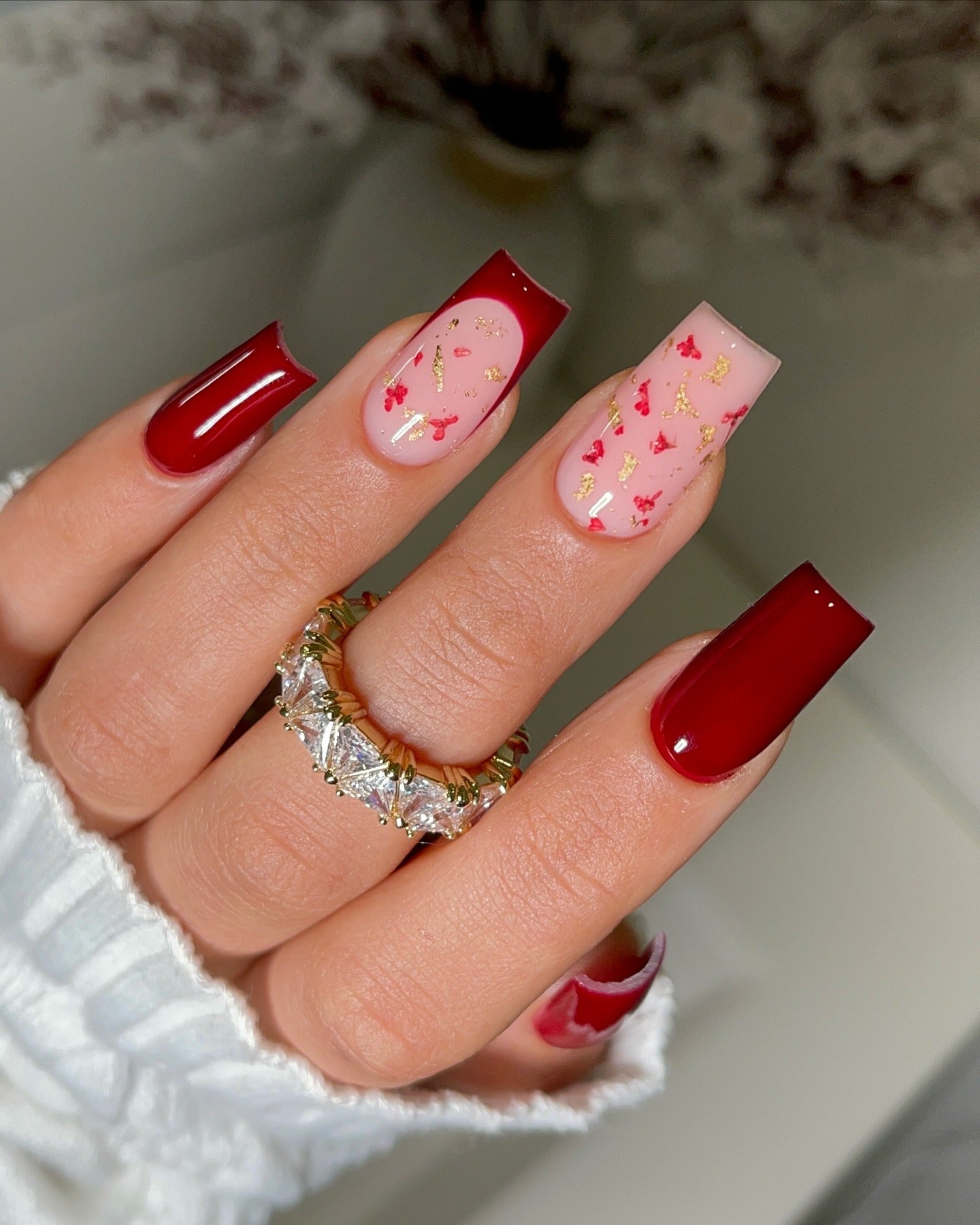 2. Glossy Red and Gold-Leaf French Tips (Red Prom Nail Ideas)