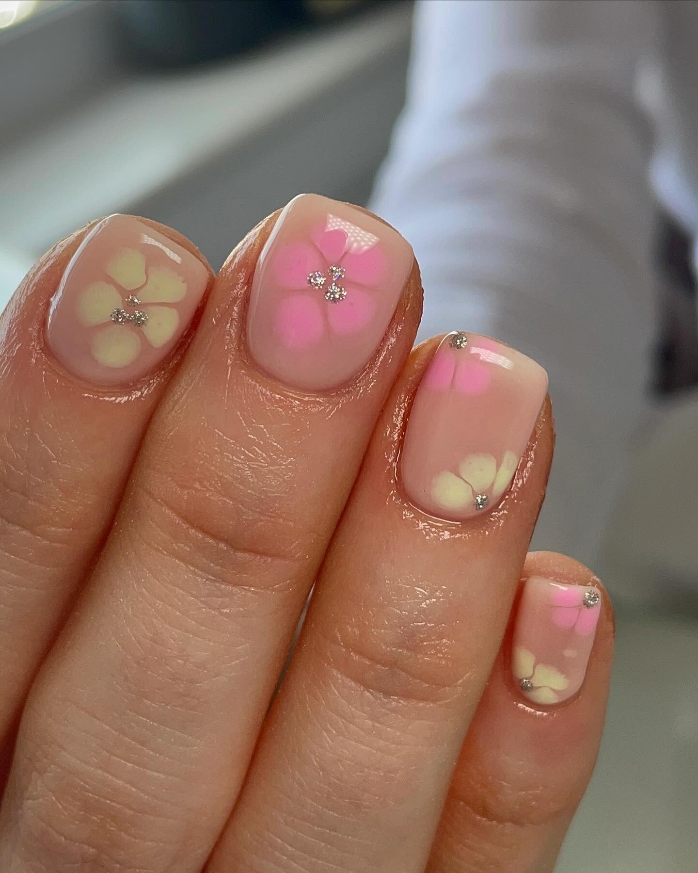 7. Pastel Petal Nails with Crystal Centers (Short Spring Break Nail Ideas)