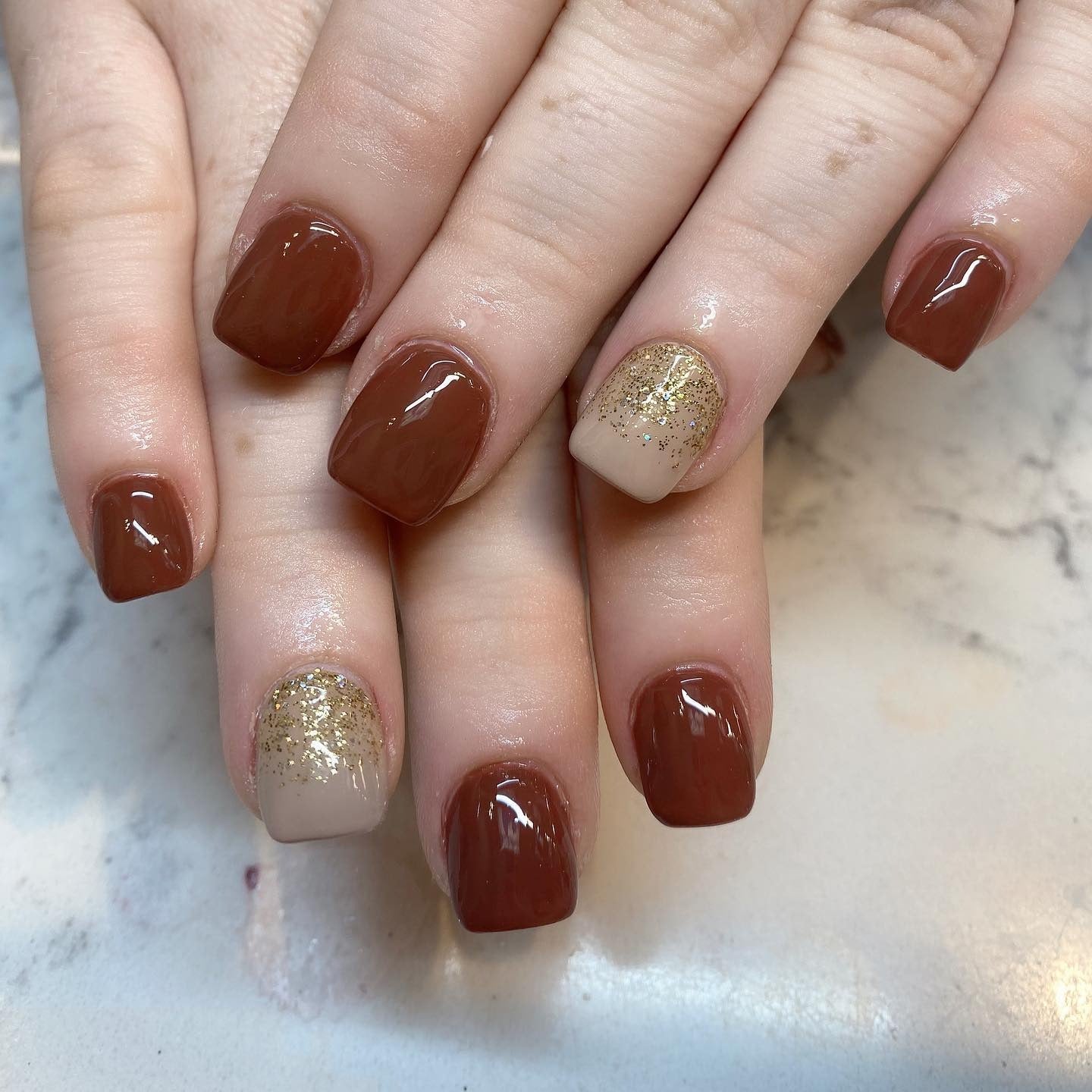 7. Cocoa Glaze with Glitter Gradient Accent (Short Thanksgiving Nail Ideas)