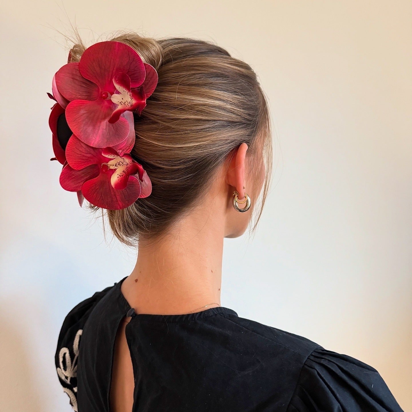 2. Sleek Chignon with Orchid Accent (Simple Hairstyles)