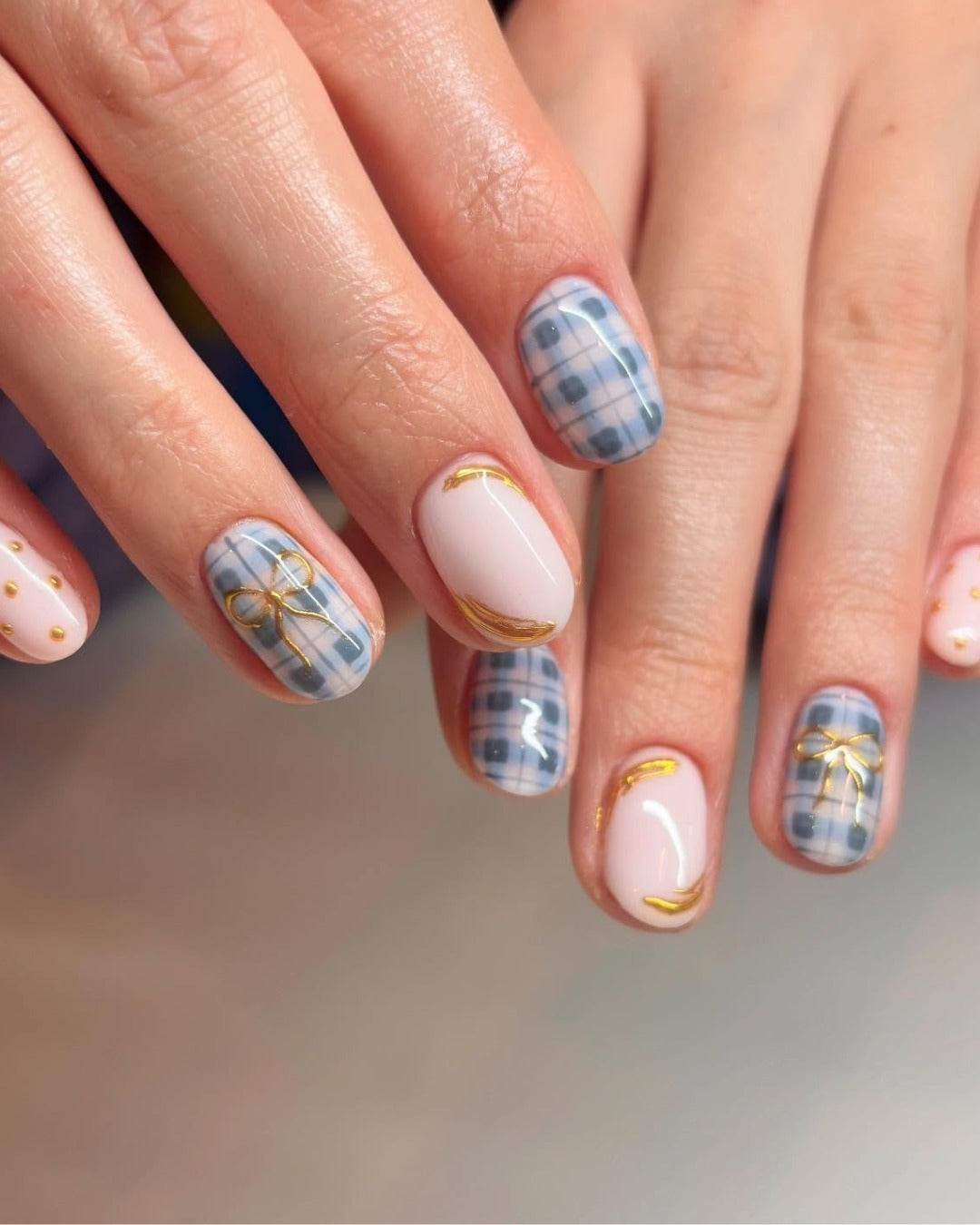 5. Navy Plaid and Gold Bow Accent (Office Nail Ideas)