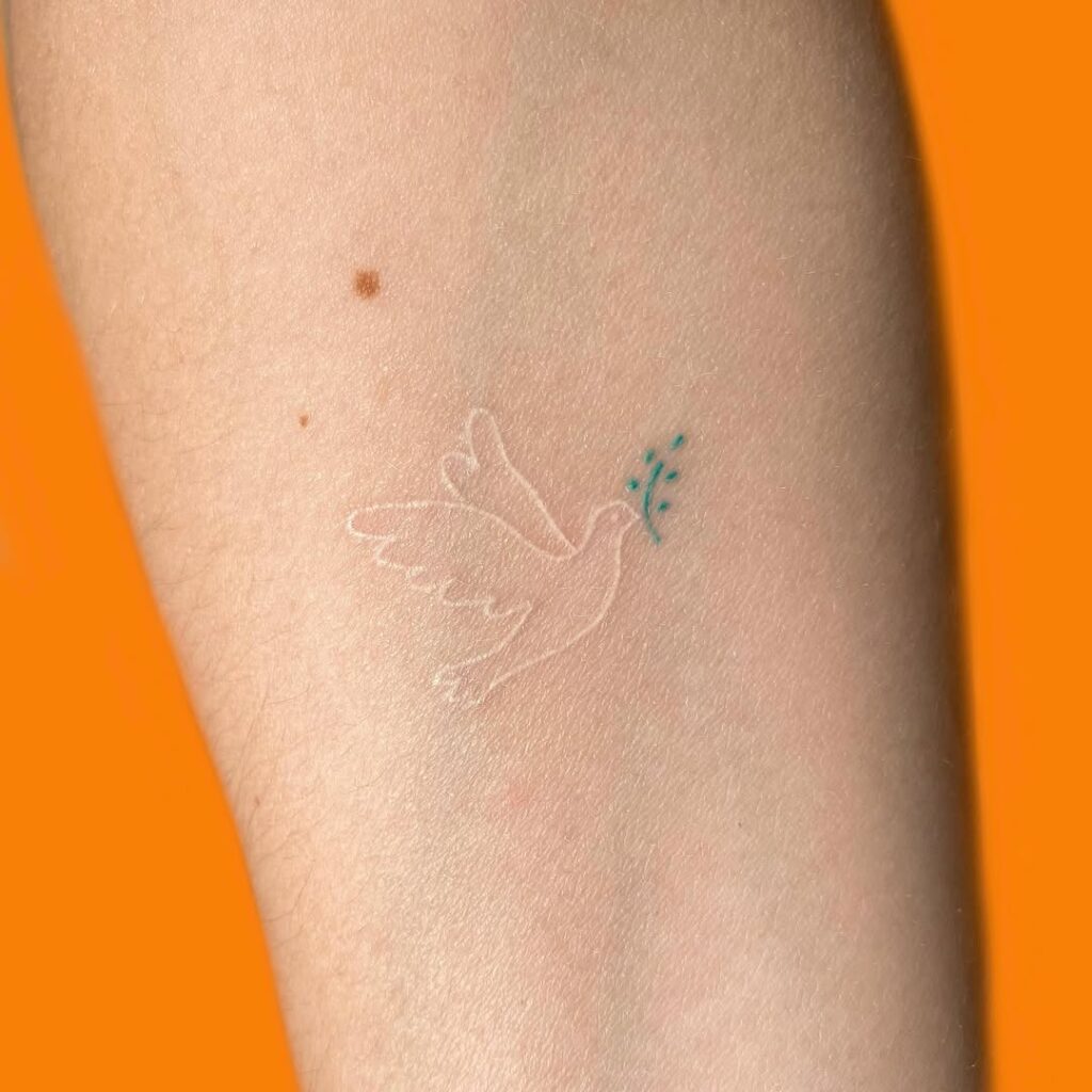 Tiny White Dove Tattoo