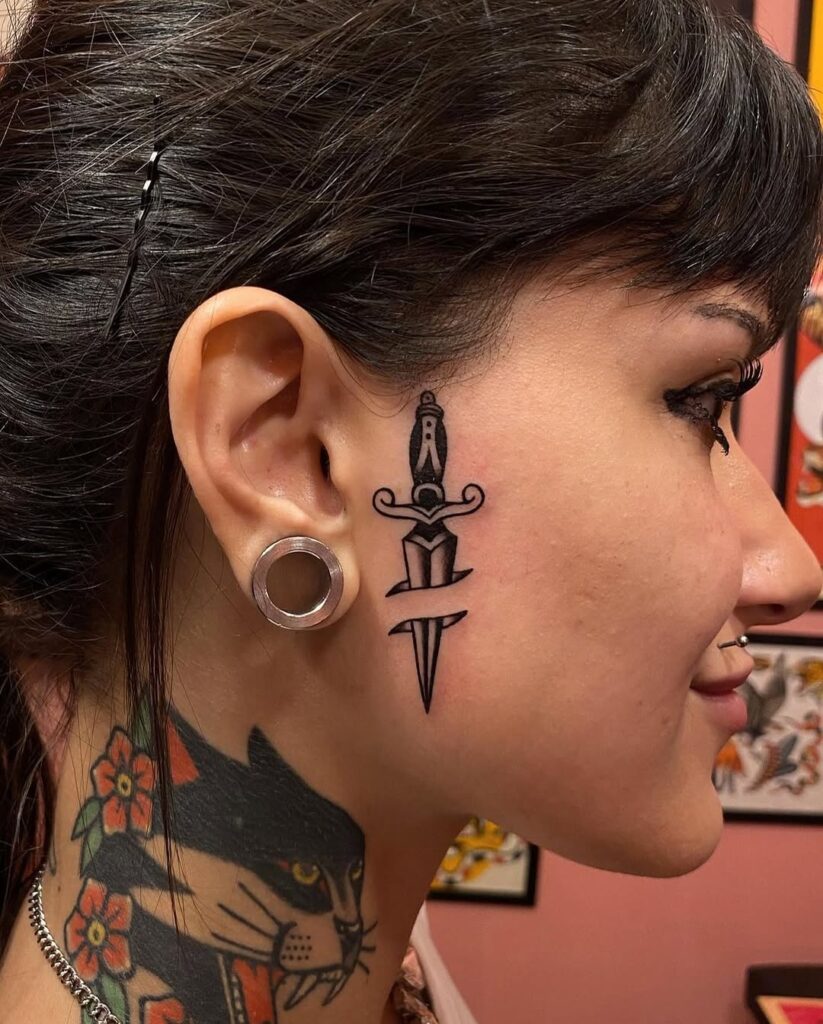  Black Sword Face Tattoo