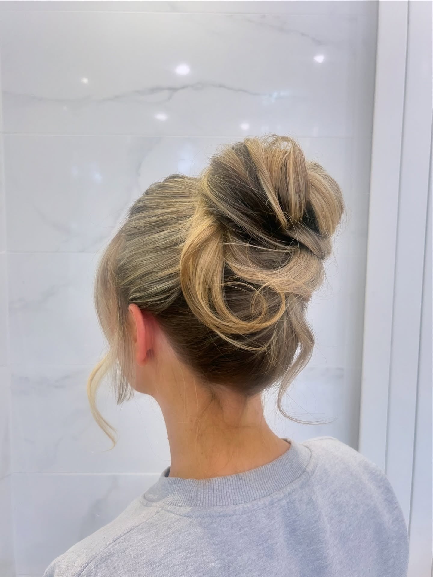 15. Twisted Bun with Loose Waves – Blonde Balayage (Cute Hairstyles)