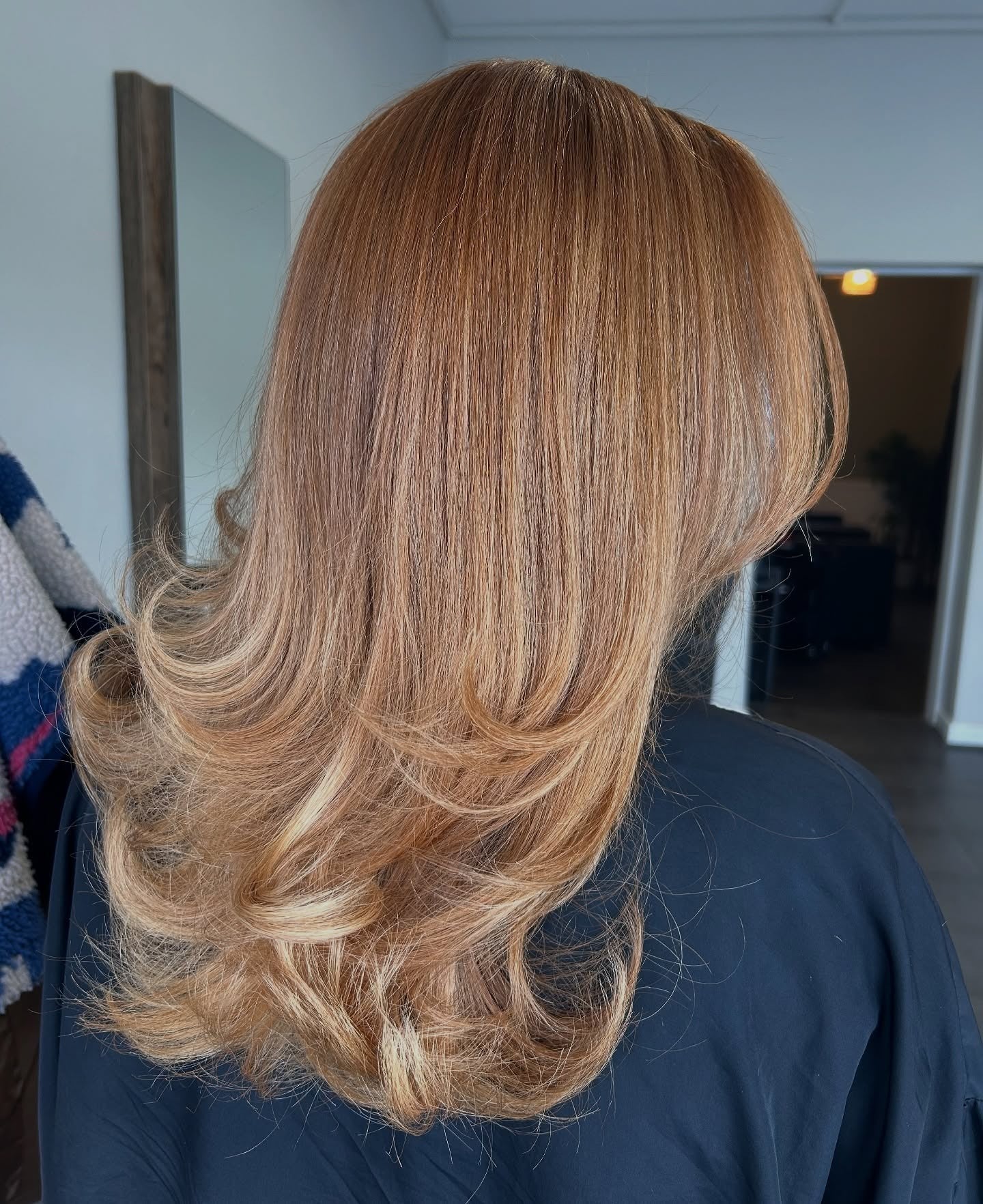 10. Feathered Strawberry Blonde with a Soft Flip (Strawberry Blonde Hair Color)