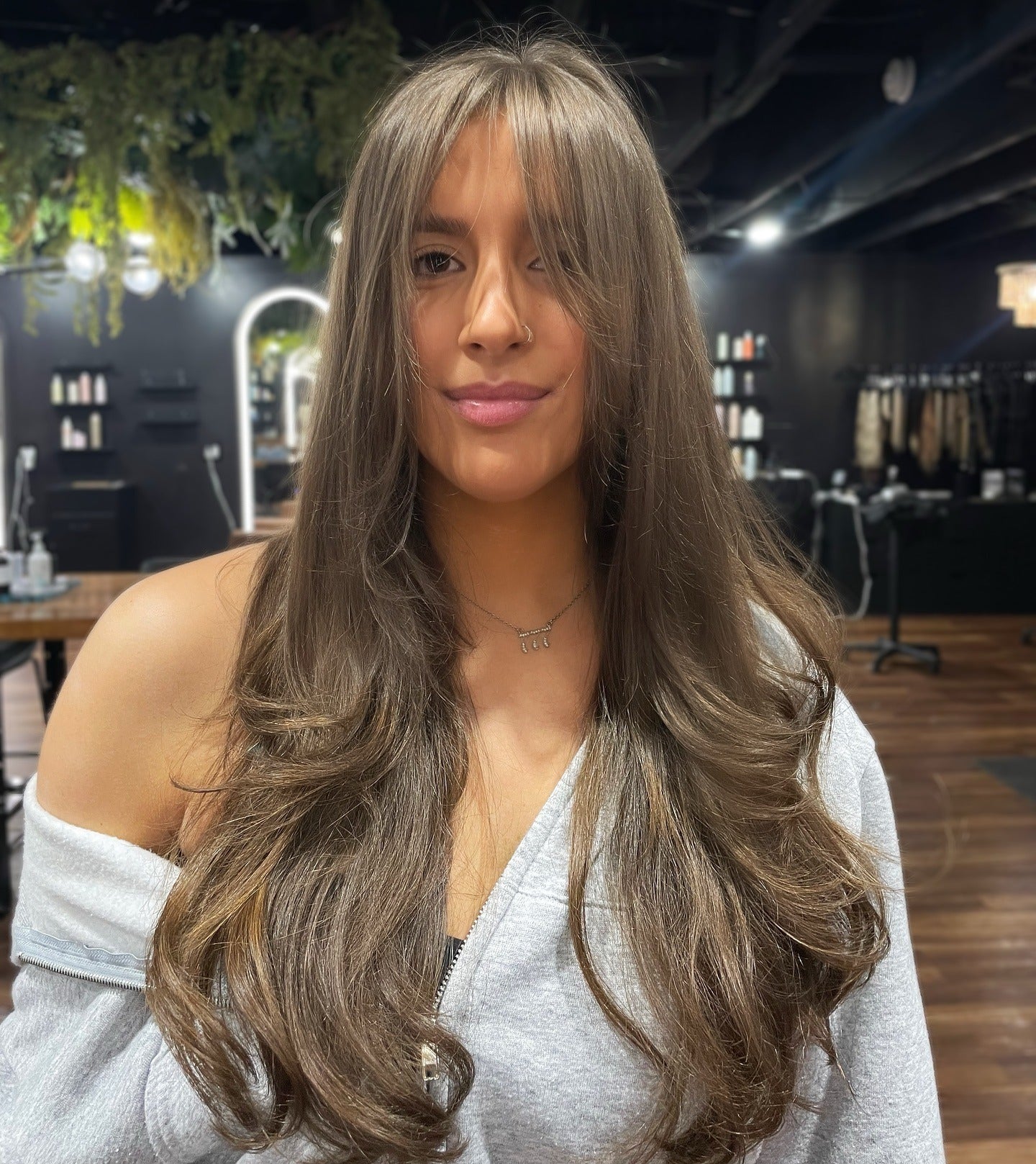 7. Ash Brown Layers with Curtain Bangs (Face-Framing Haircuts)