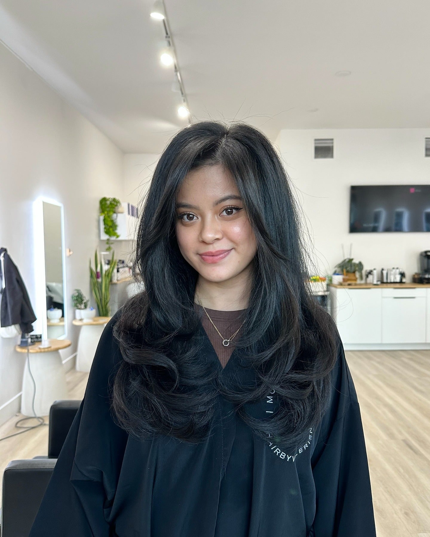 11. Voluminous Jet Black Layers with Soft Face Frame (Face-Framing Haircuts)