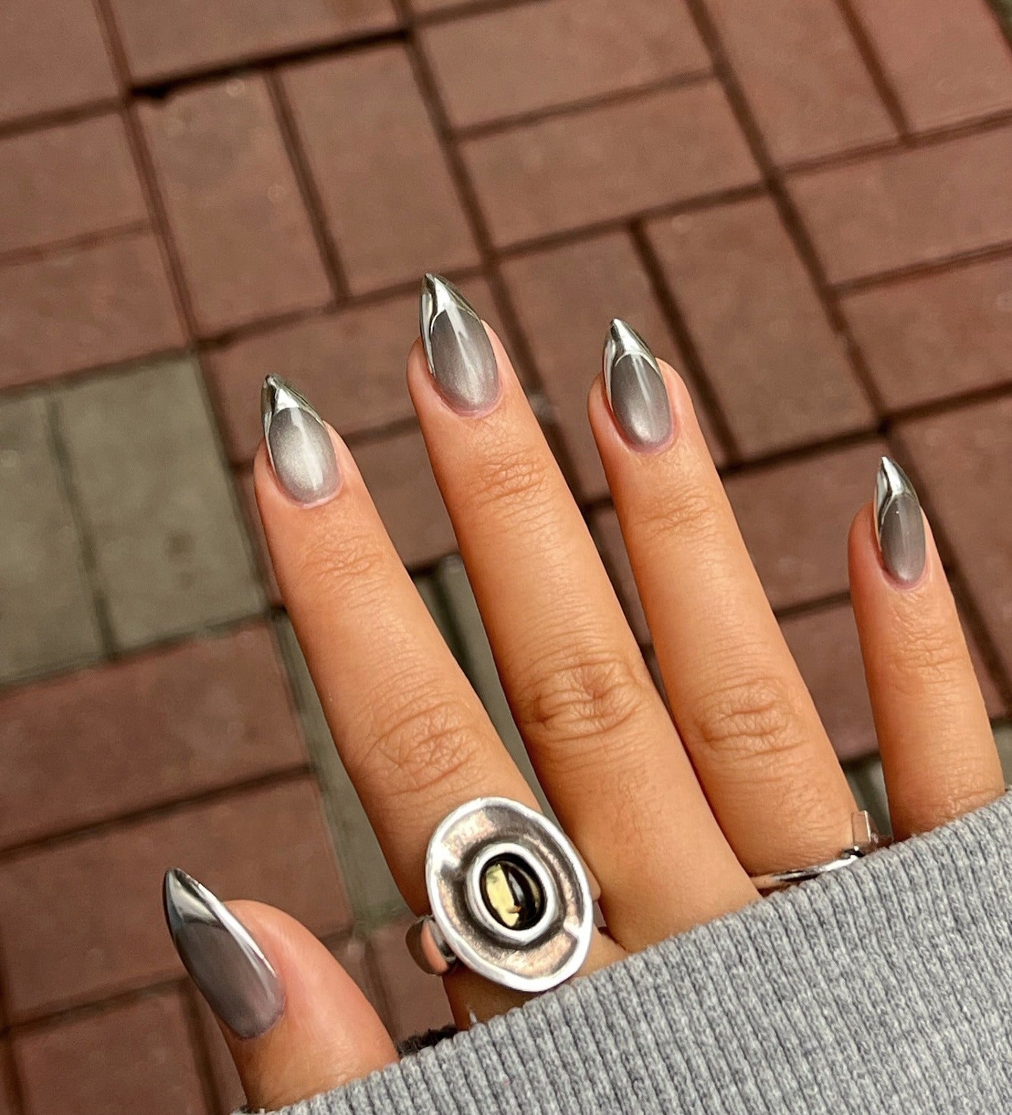 2. Silver Cat Eye Tips on Almond Base (Grunge Nail Ideas)