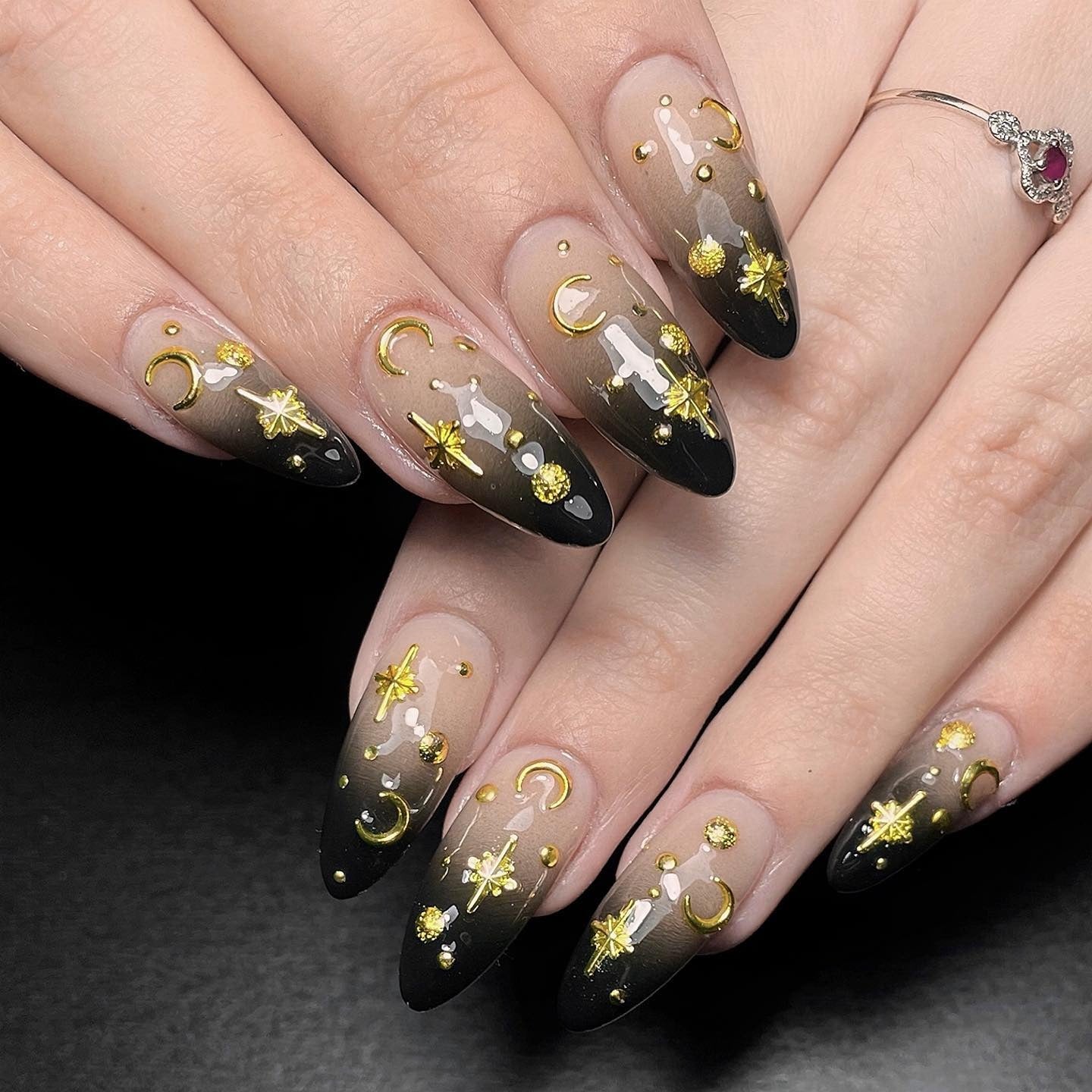 3. Cosmic Fade with Gold Symbol Accents (Grunge Nail Ideas)