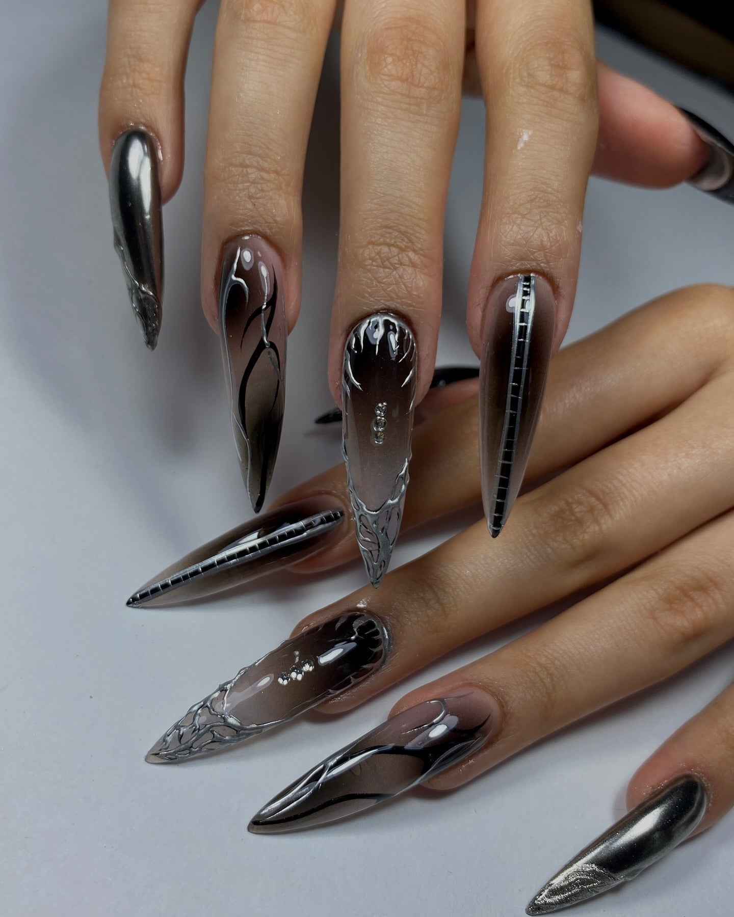 7. Smoky Chrome with Wireframe Details (Grunge Nail Ideas)