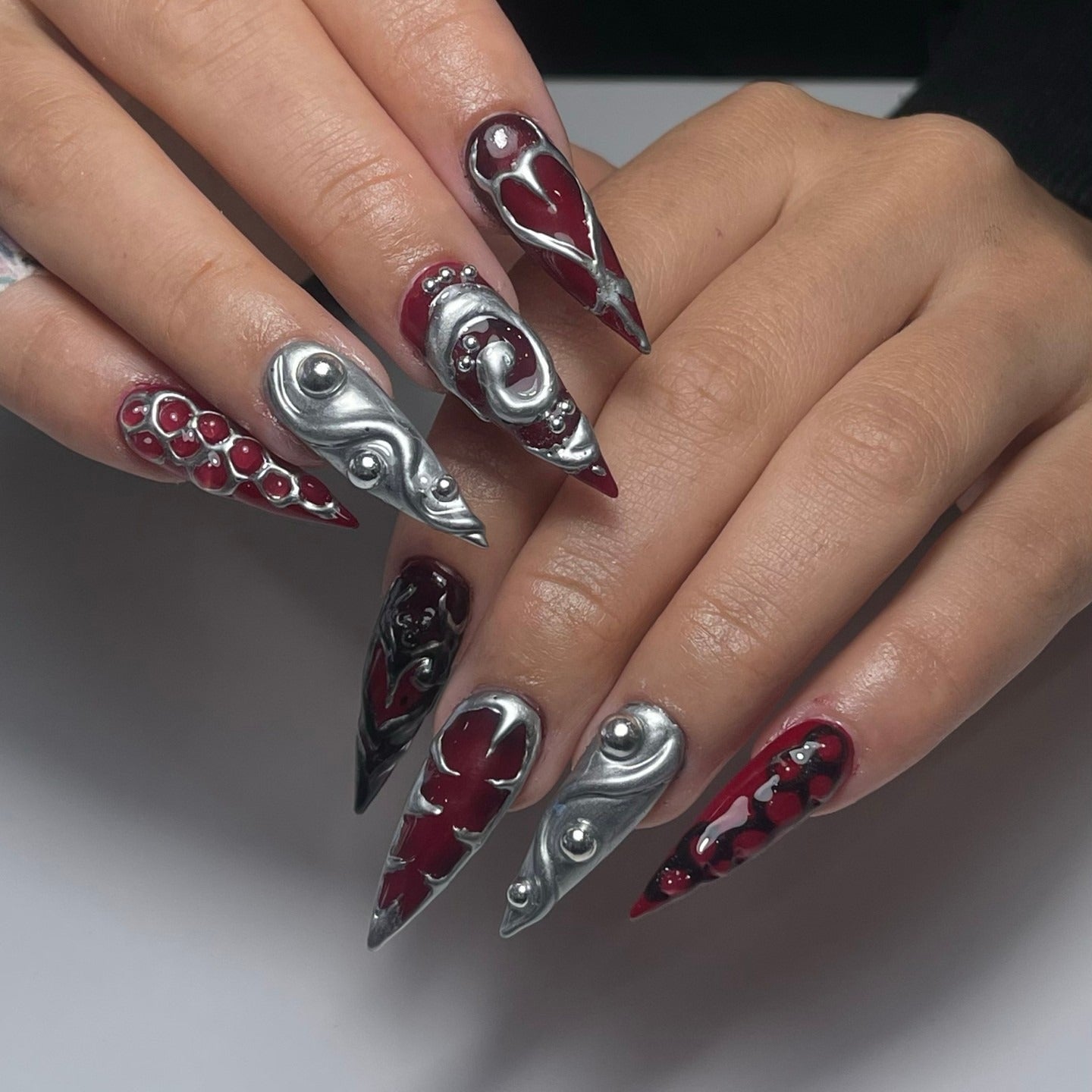 9. Blood Red and Chrome Sculpted Hearts (Grunge Nail Ideas)