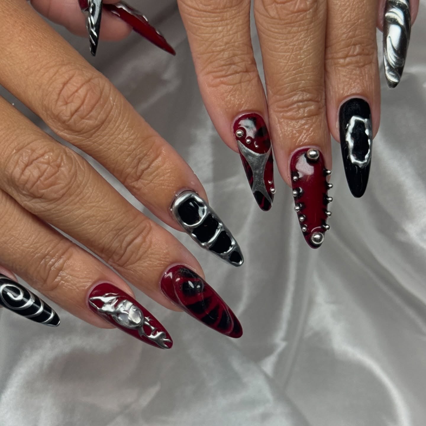 10. Black & Crimson Cyber Spikes (Grunge Nail Ideas)