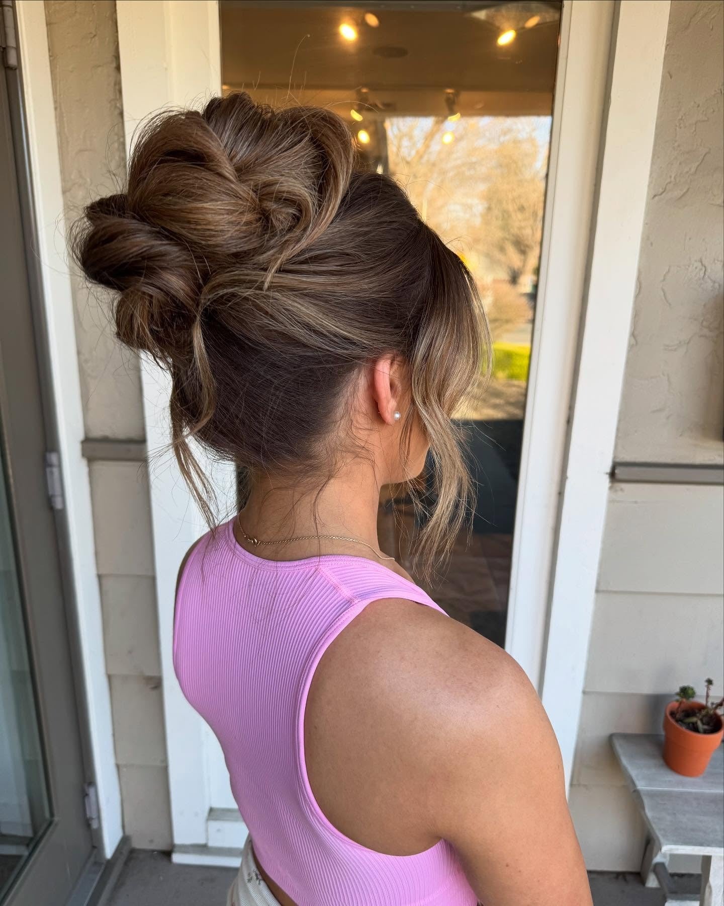 11. Textured Brunette High Bun with Face-Framing Layers (Birthday Hairstyles)