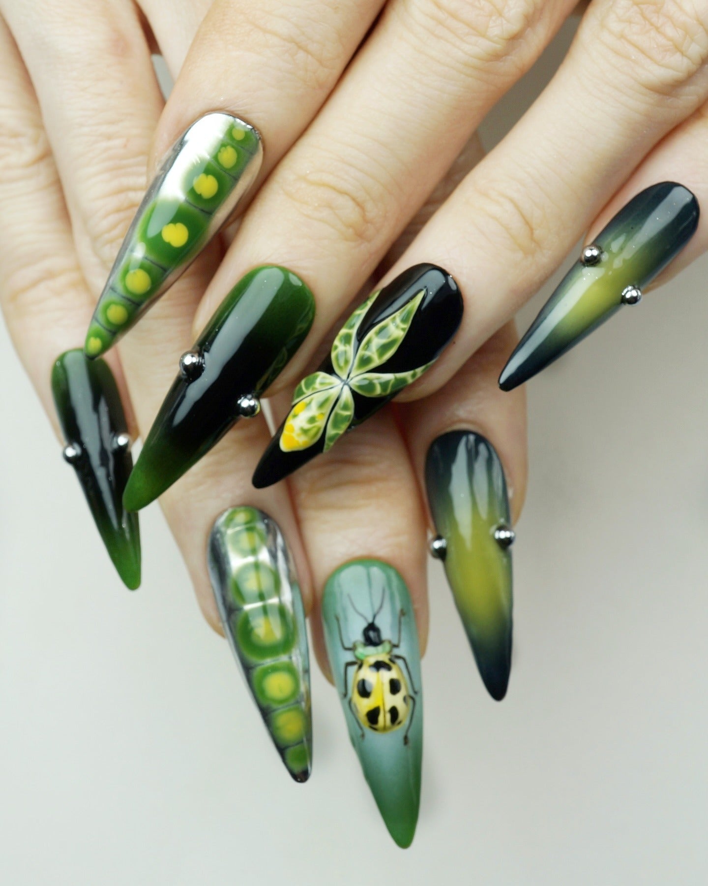 2. Insect Garden Stiletto Art (Nature Nail Ideas)