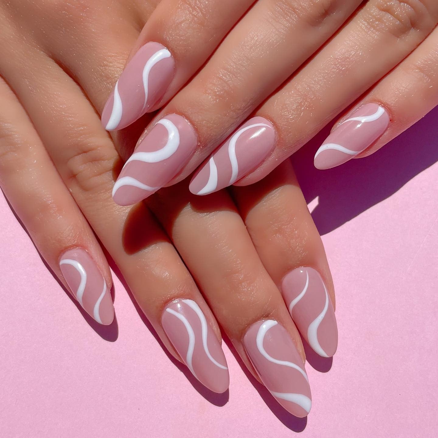 11. Soft Pink Almond with White Wave Art (Pink and White Nail Ideas)