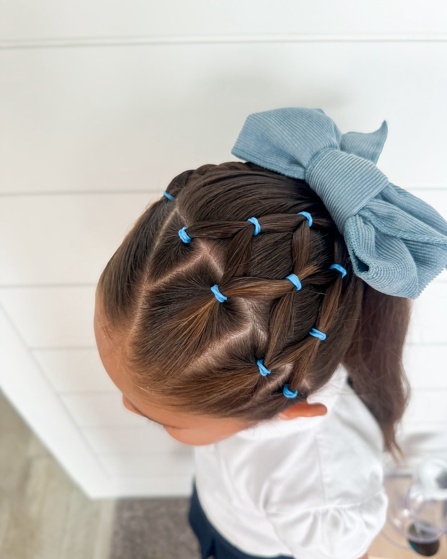 12. Crisscross Elastic Ponytail with Blue Bow on Dark Brown Hair (Hairstyles For School)