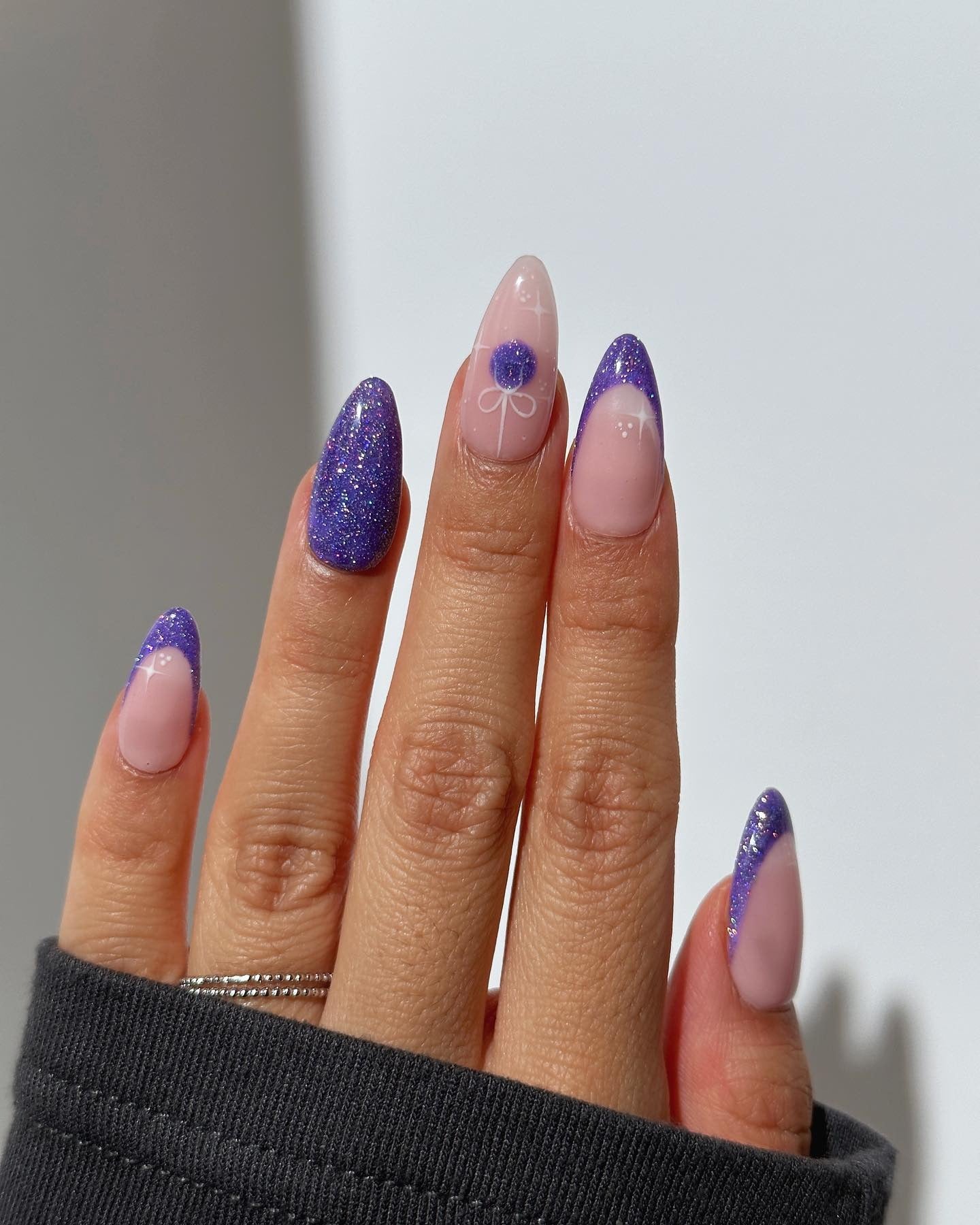 1. Purple Sparkle French with Floral Accent (Glitter Nail Ideas)