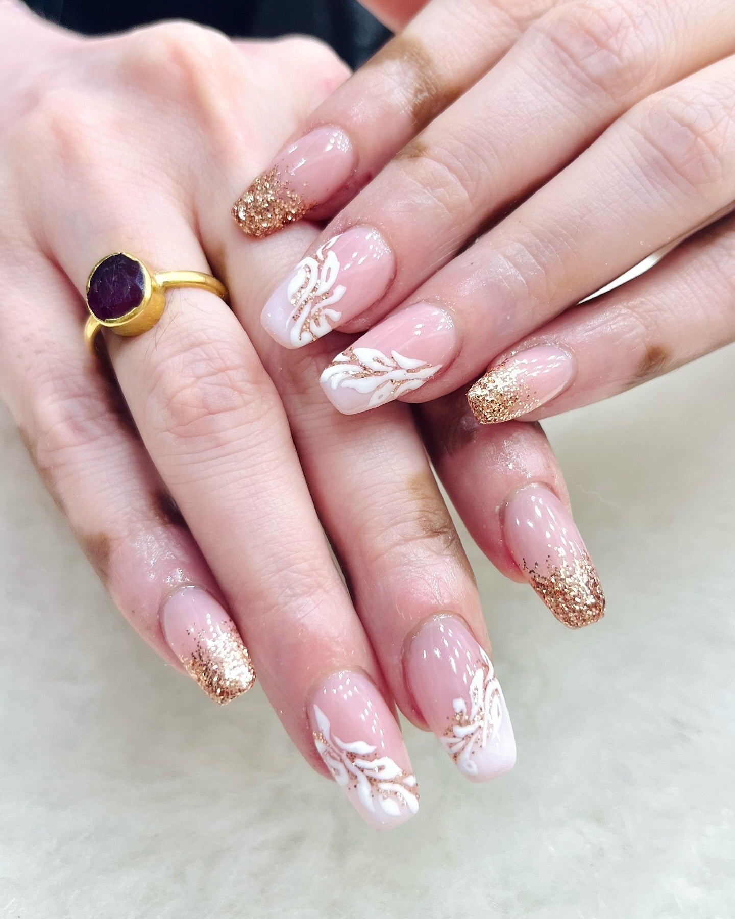 3. Rose Gold Glitter with White Leaf Art (Glitter Nail Ideas)