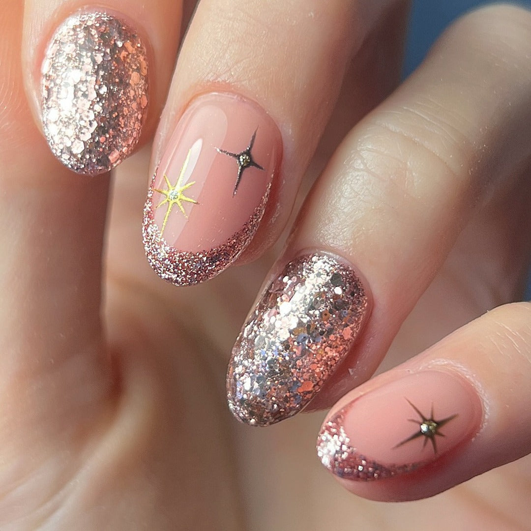 13. Rose Gold Glitter with Star Accents (Glitter Nail Ideas)