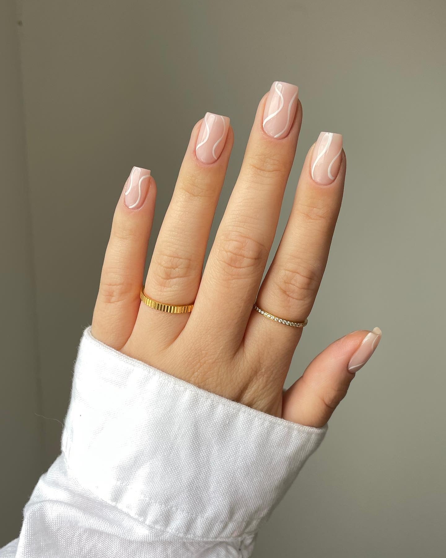 7. Minimalist Pink with Glossy Swirls (Holiday Nail Ideas)