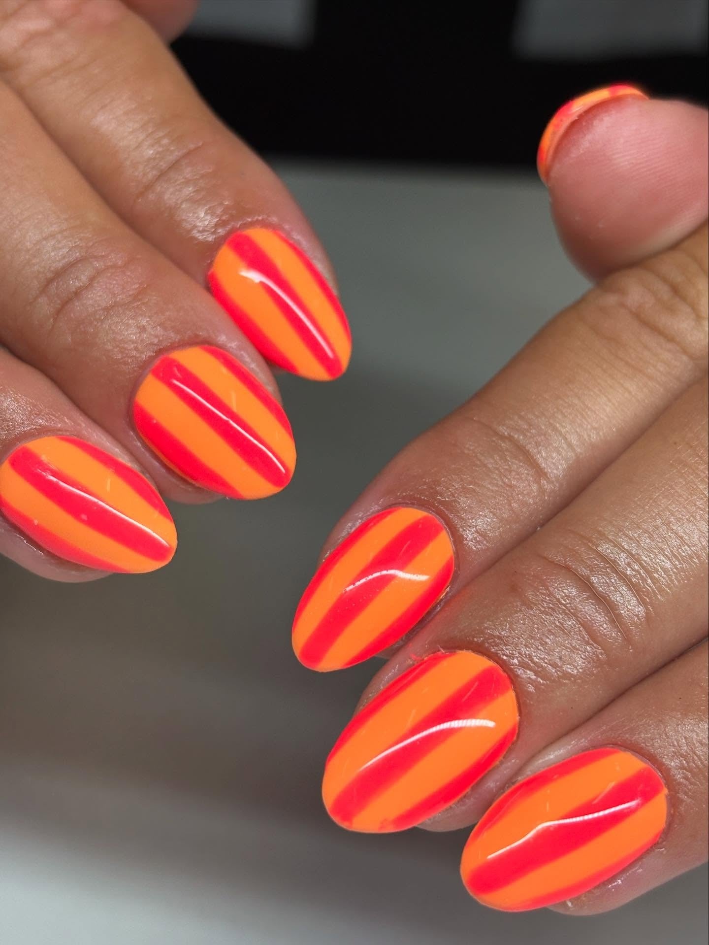2. Tangerine and Coral Stripe Almond Nails (Orange Color Nail Ideas)