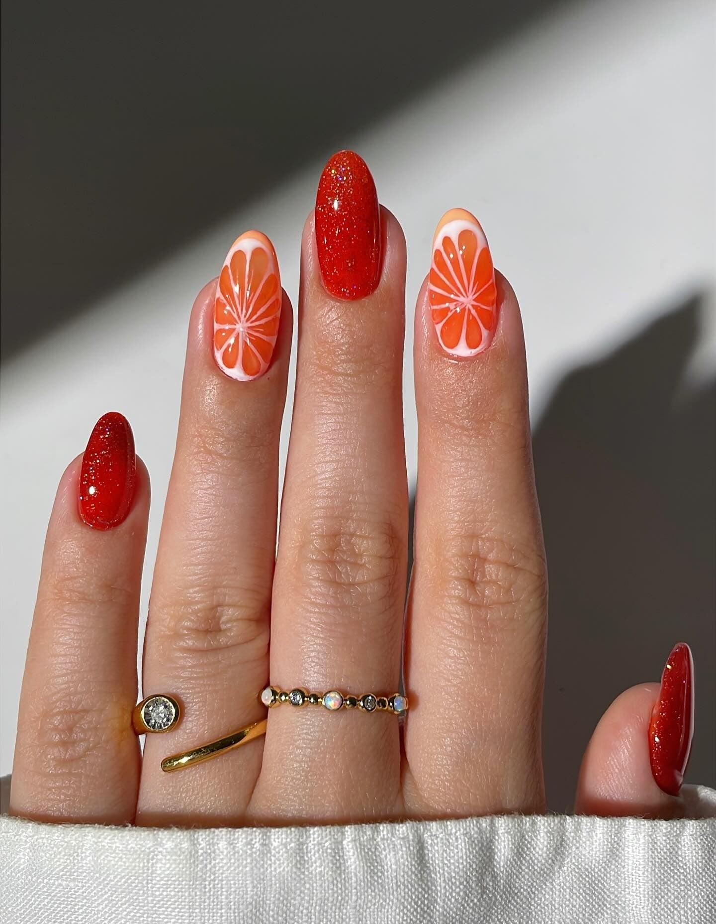 7. Citrus Slice and Glitter Mix Nails (Orange Color Nail Ideas)