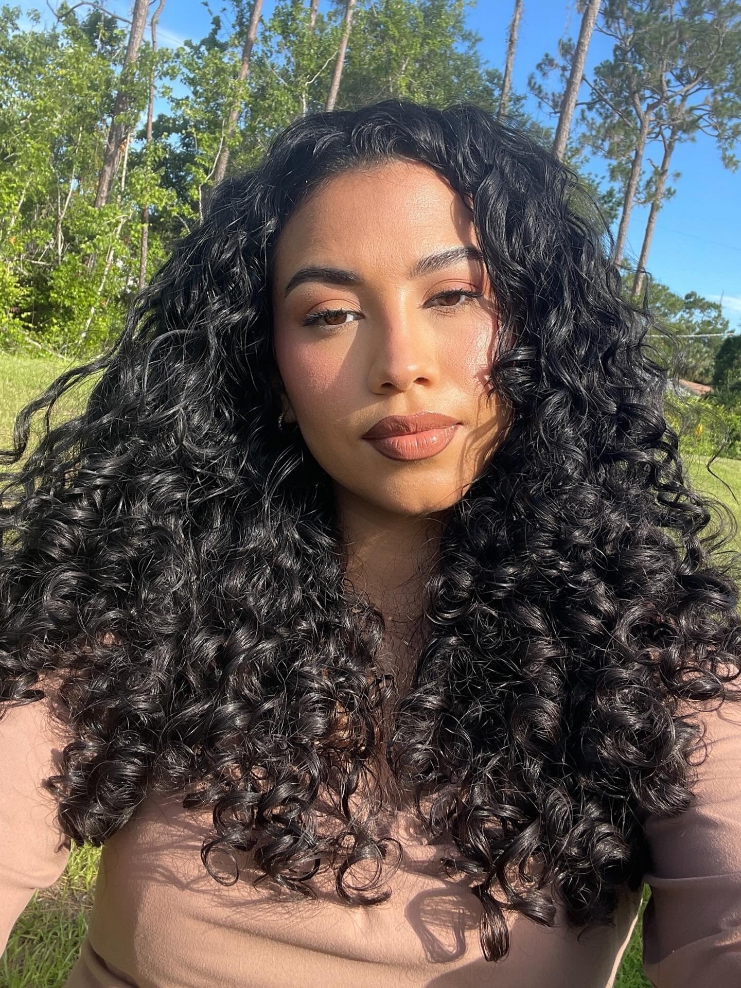 9. Glossy Black Layers with Face-Framing Curls (Layered Curly Hairstyles)