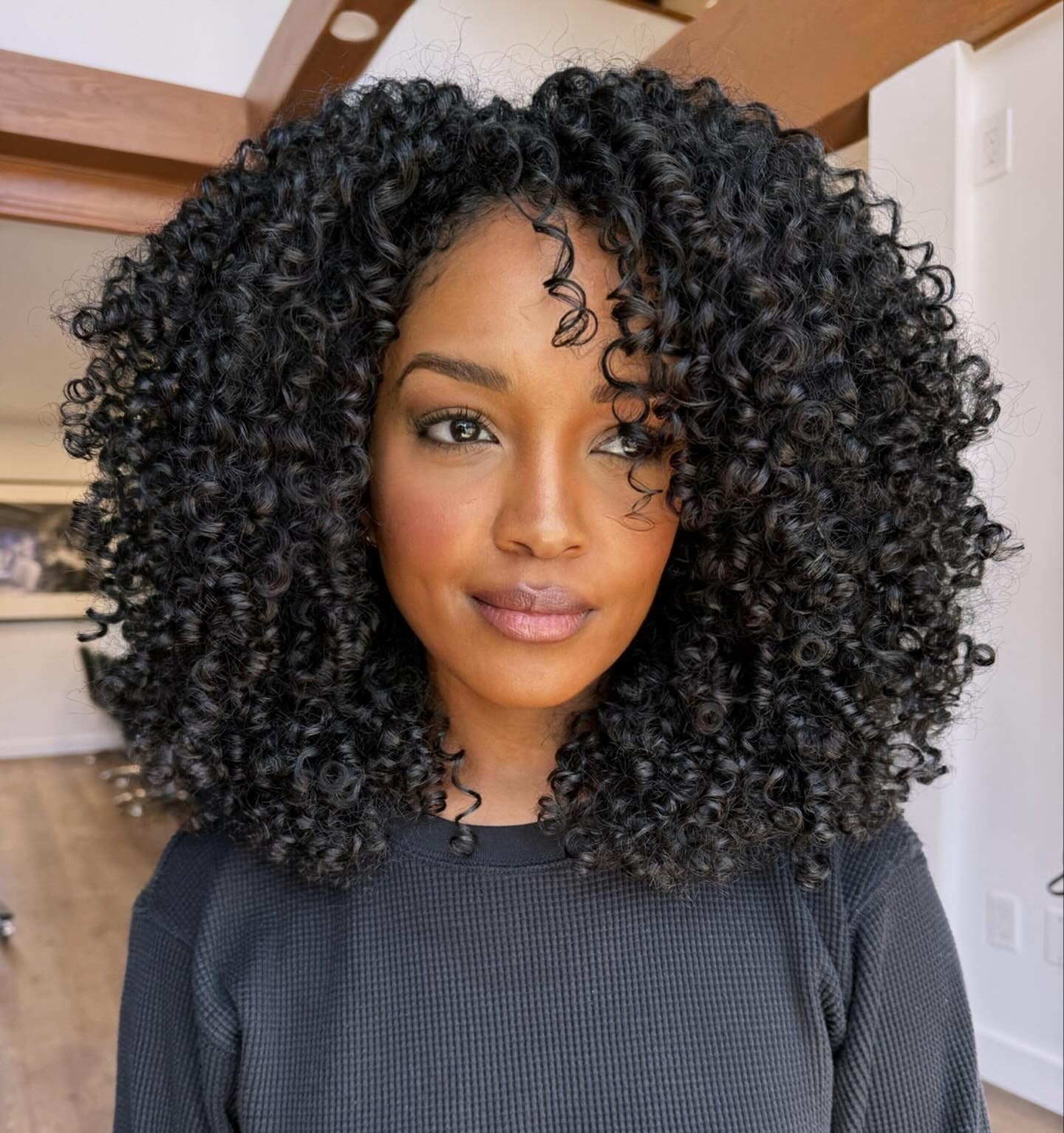 11. Voluminous Layers with Jet Black Curls (Layered Curly Hairstyles)