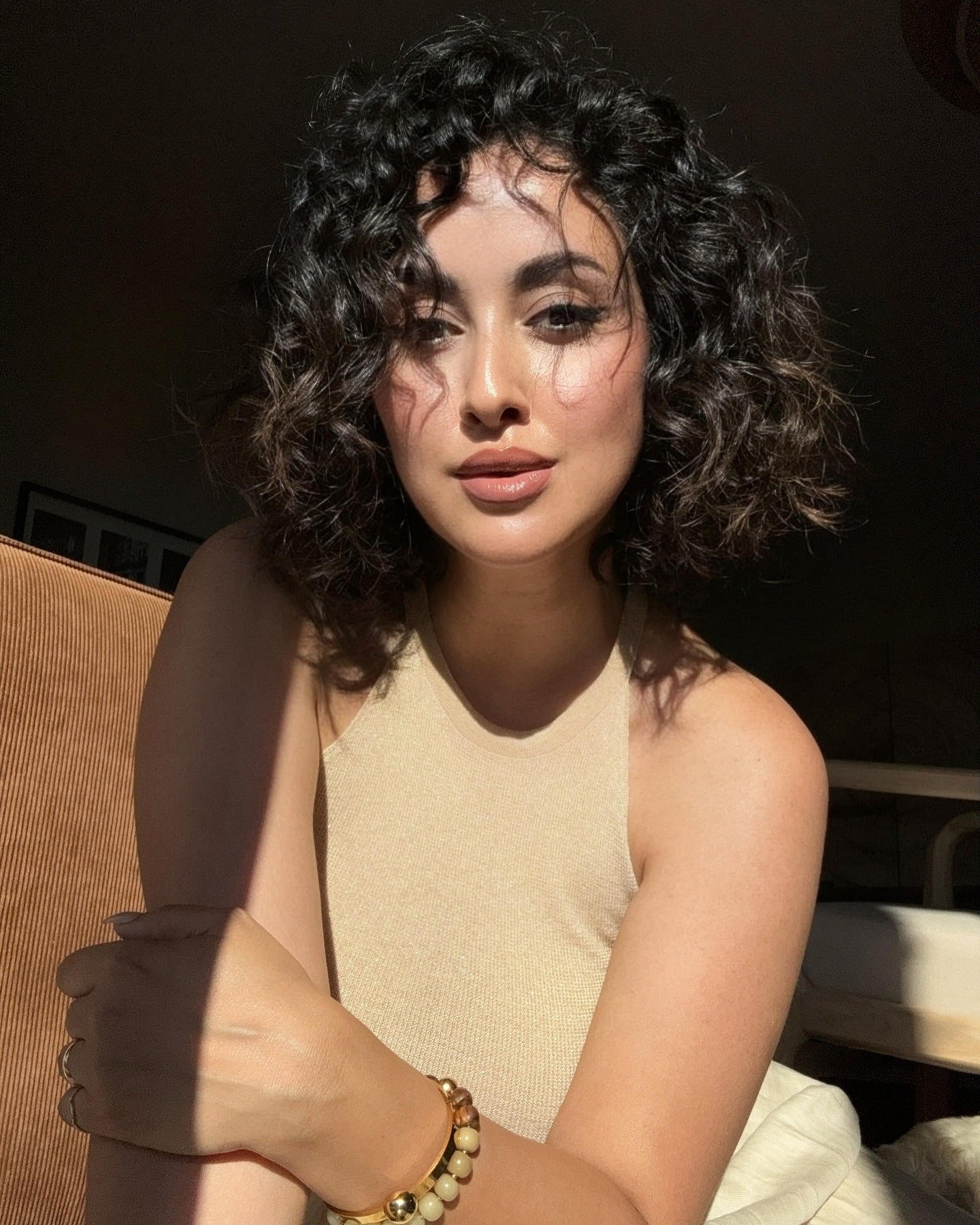 13. Chin-Length Curly Bob with Warm Brunette Blend (Layered Curly Hairstyles)