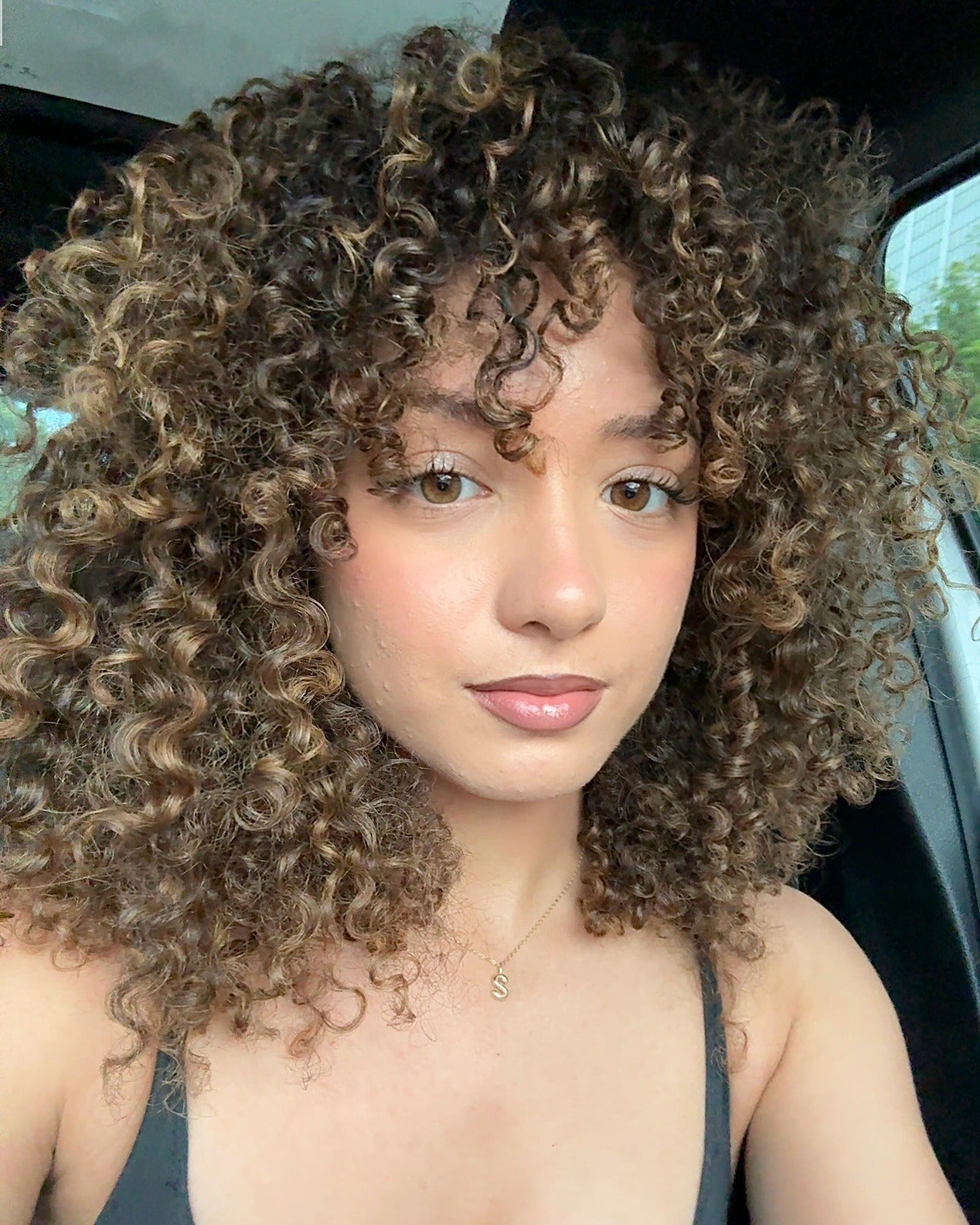 14. Rounded Layered Curls with Toffee Highlights (Layered Curly Hairstyles)